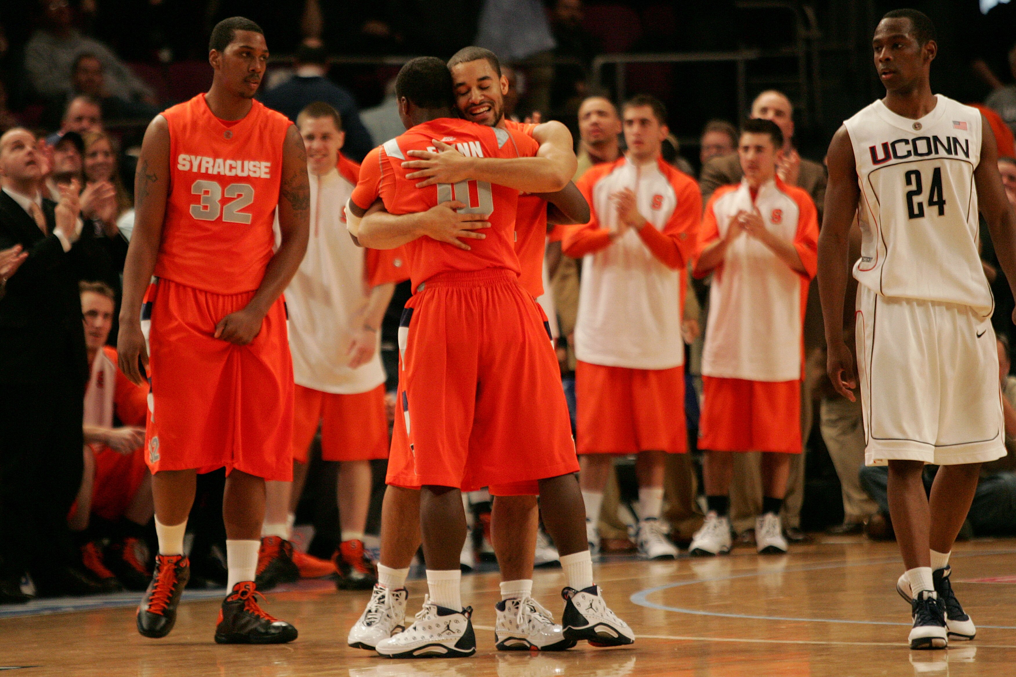 NEW YORK - MARCH 12:  Justin Thomas #2 and Jonny Flynn #10 of the Syracuse Orange celebrate late in the sixth overtime as Craig Austrie #24 of the Connecticut Huskies looks on during the quarterfinal round of the Big East Tournament at Madison Square Gard