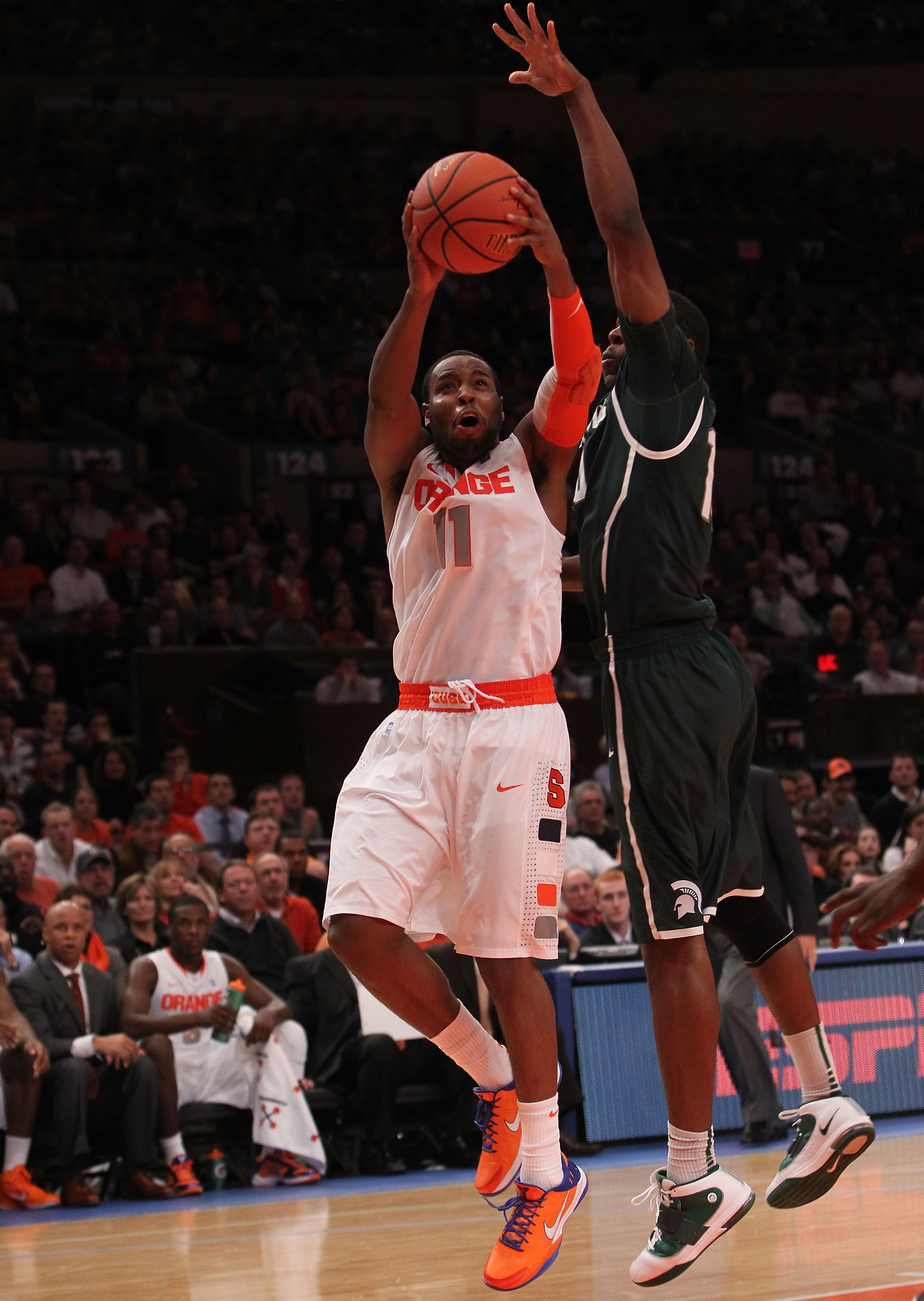 NEW YORK, NY - DECEMBER 07: Scoop Jardine #11 of Syracuse Orange shoots the ball against Delvon Roe #10 of the Michigan State Spartans during their game at the Jimmy V Classic at Madison Square Garden on December 7, 2010 in New York City.  (Photo by Nick