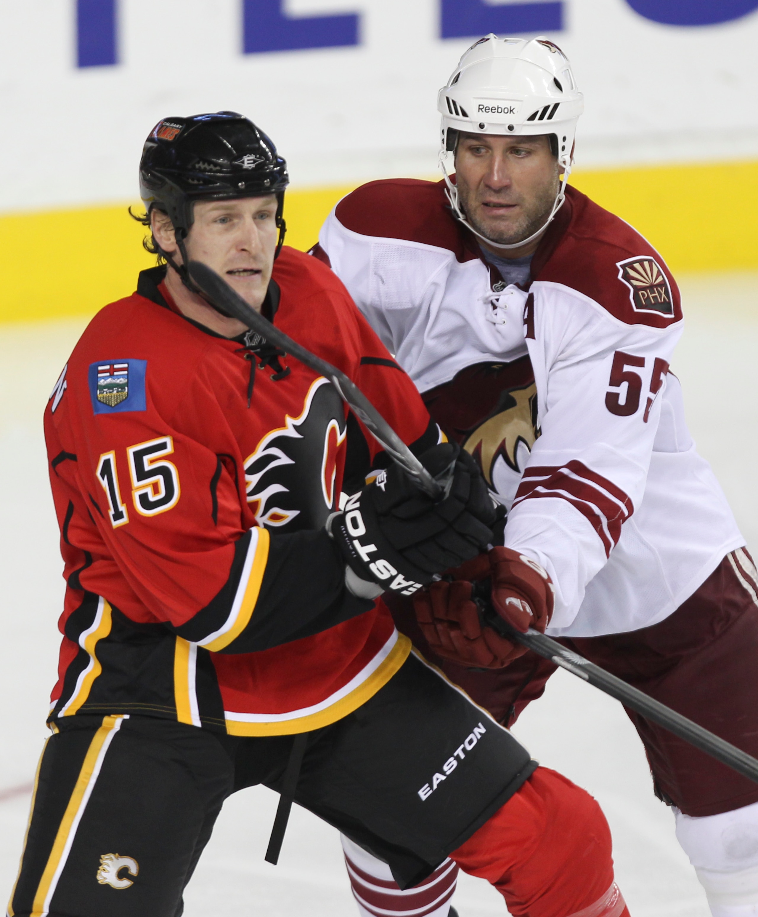CALGARY, AB - SEPTEMBER 28: Tim Jackman #15  of the Calgary Flames battles Ed Jovanovski #55 of the Phoenix Coyotes in NHL preseason action on September 28, 2010 at the Pengrowth Saddledome in Calgary, Alberta, Canada. (Photo by Mike Ridewood/Getty Images