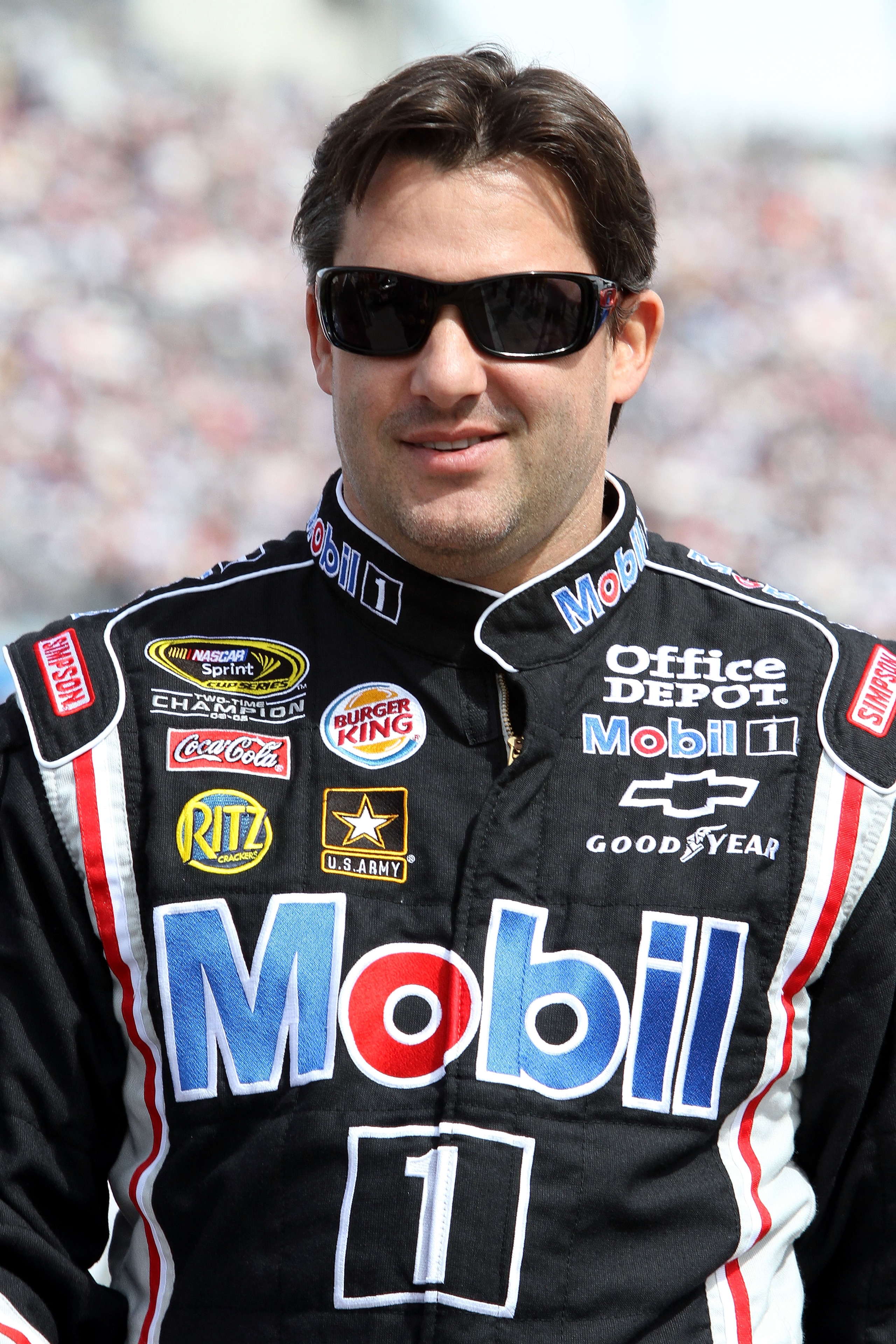LAS VEGAS, NV - MARCH 06:  Tony Stewart, driver of the #14 Mobil 1/Office Depot Chevrolet, walks on the grid prior to the start of the NASCAR Sprint Cup Series Kobalt Tools 400 at Las Vegas Motor Speedway on March 6, 2011 in Las Vegas, Nevada.  (Photo by