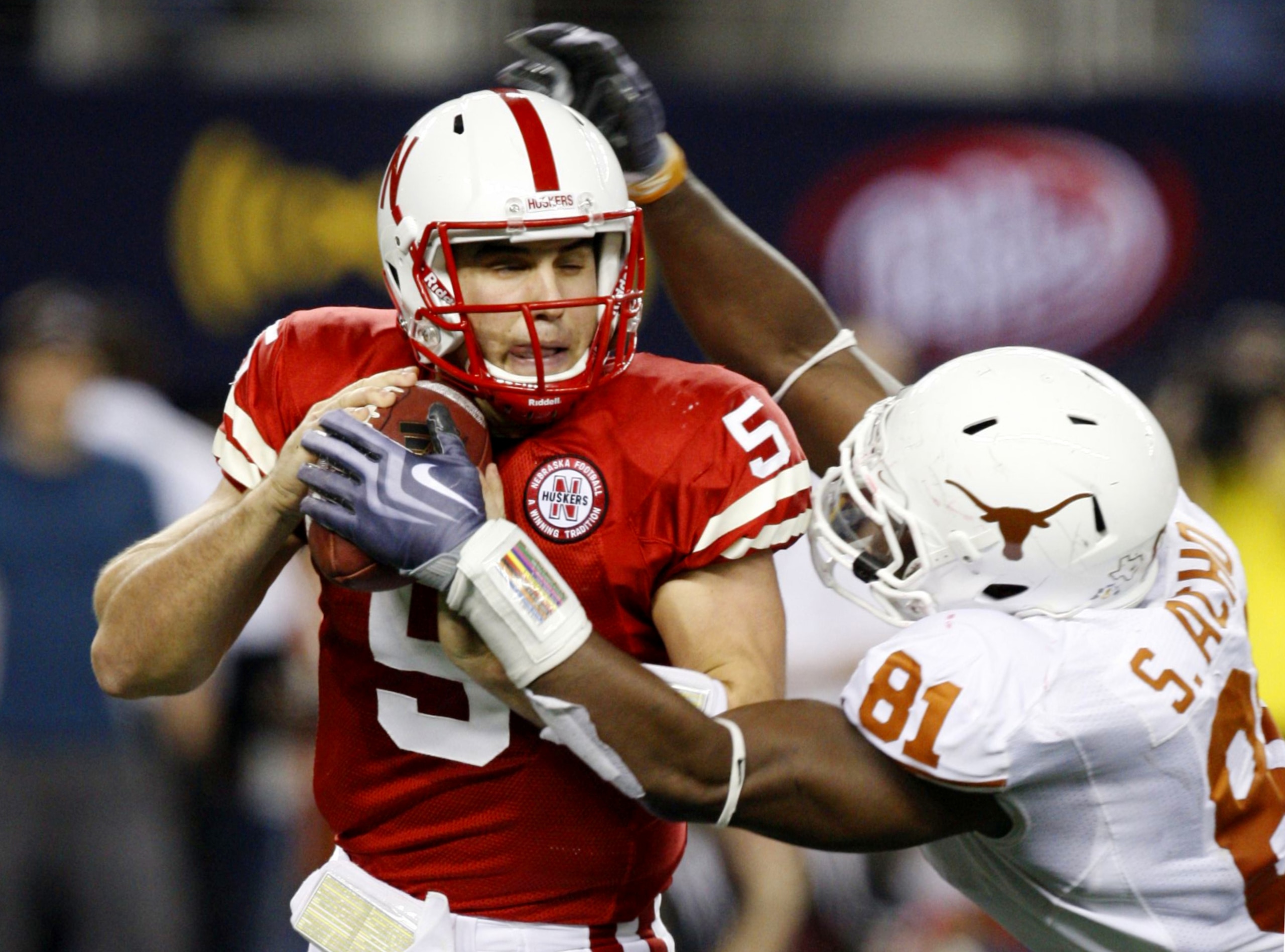 ARLINGTON, TX - DECEMBER 5: Quarterback Zac Lee of the Nebraska Cornhuskers is sacked by Sam Acho #81 of the Texas Longhorns at Cowboys Stadium on December 5, 2009 in Arlington, Texas.  (Photo by Ronald Martinez/Getty Images)