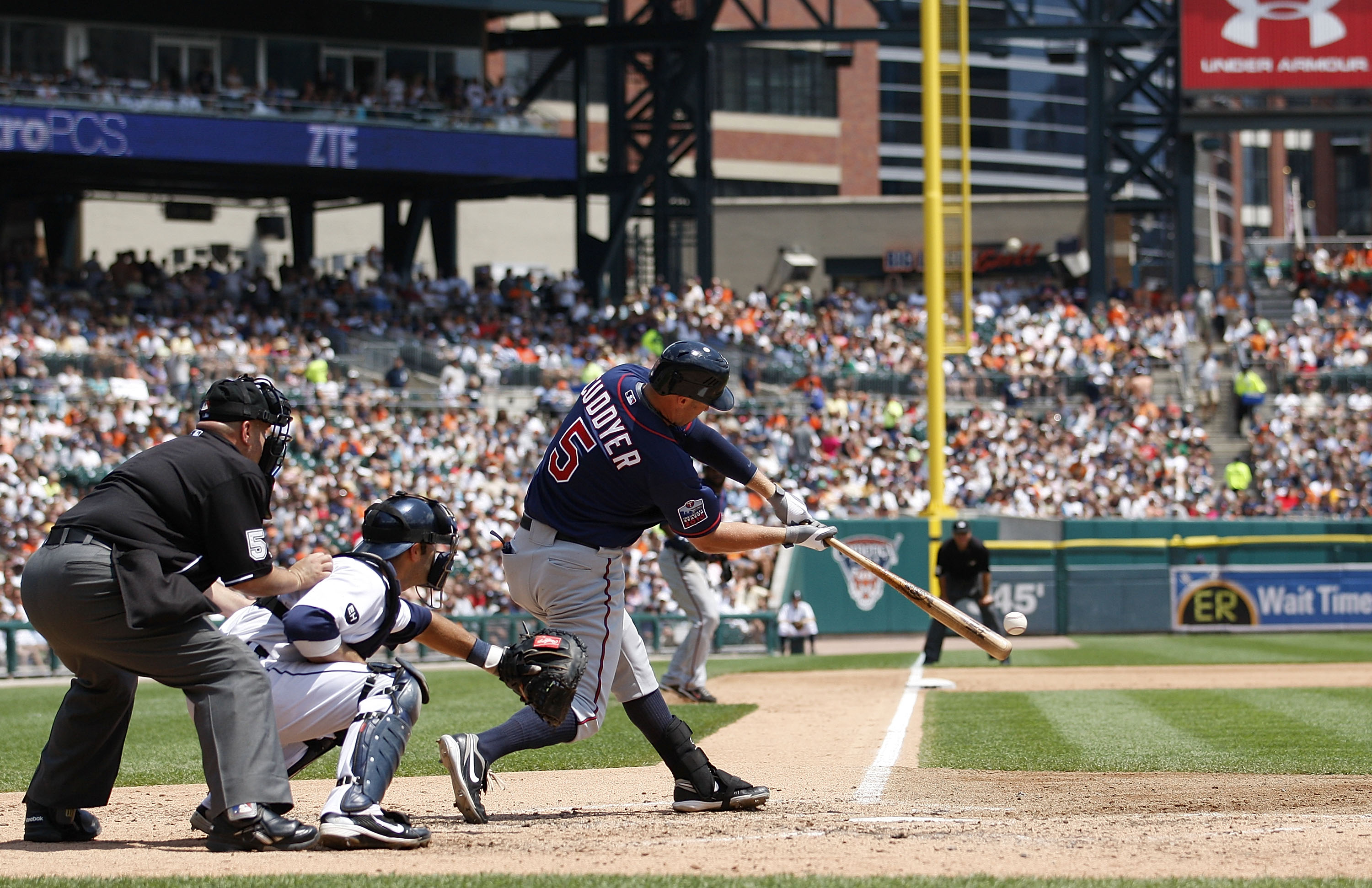 DETROIT - JULY 11: Michael Cuddyer #5 of the Minnesota Twins doubles to deep left center field in the fifth inning scoring Denard Span #2 and Delmon Young #21 during the game against the Detroit Tigers on July 11, 2010 at Comerica Park in Detroit, Michiga