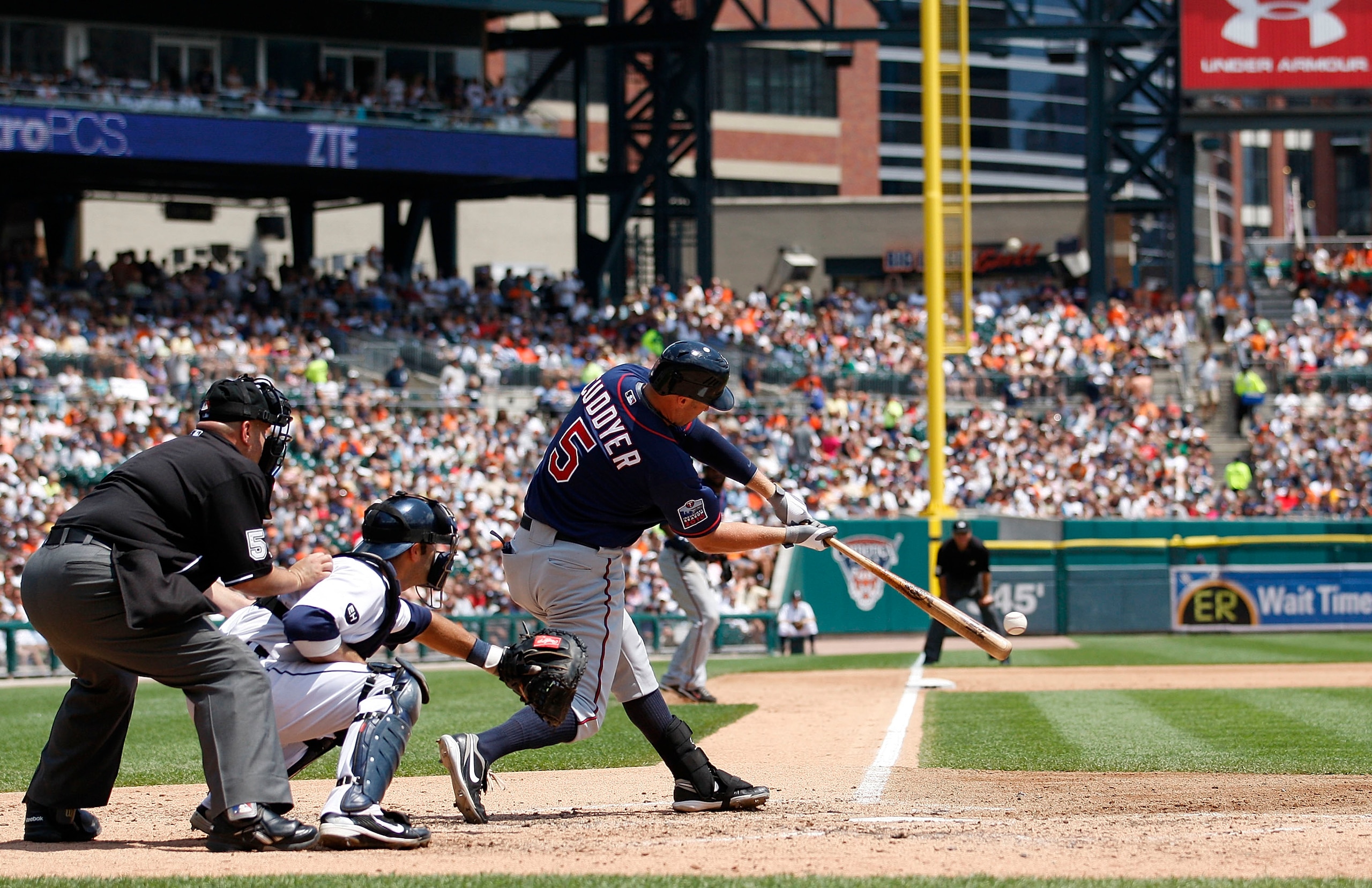 DETROIT - JULY 11: Michael Cuddyer #5 of the Minnesota Twins doubles to deep left center field in the fifth inning scoring Denard Span #2 and Delmon Young #21 during the game against the Detroit Tigers on July 11, 2010 at Comerica Park in Detroit, Michiga
