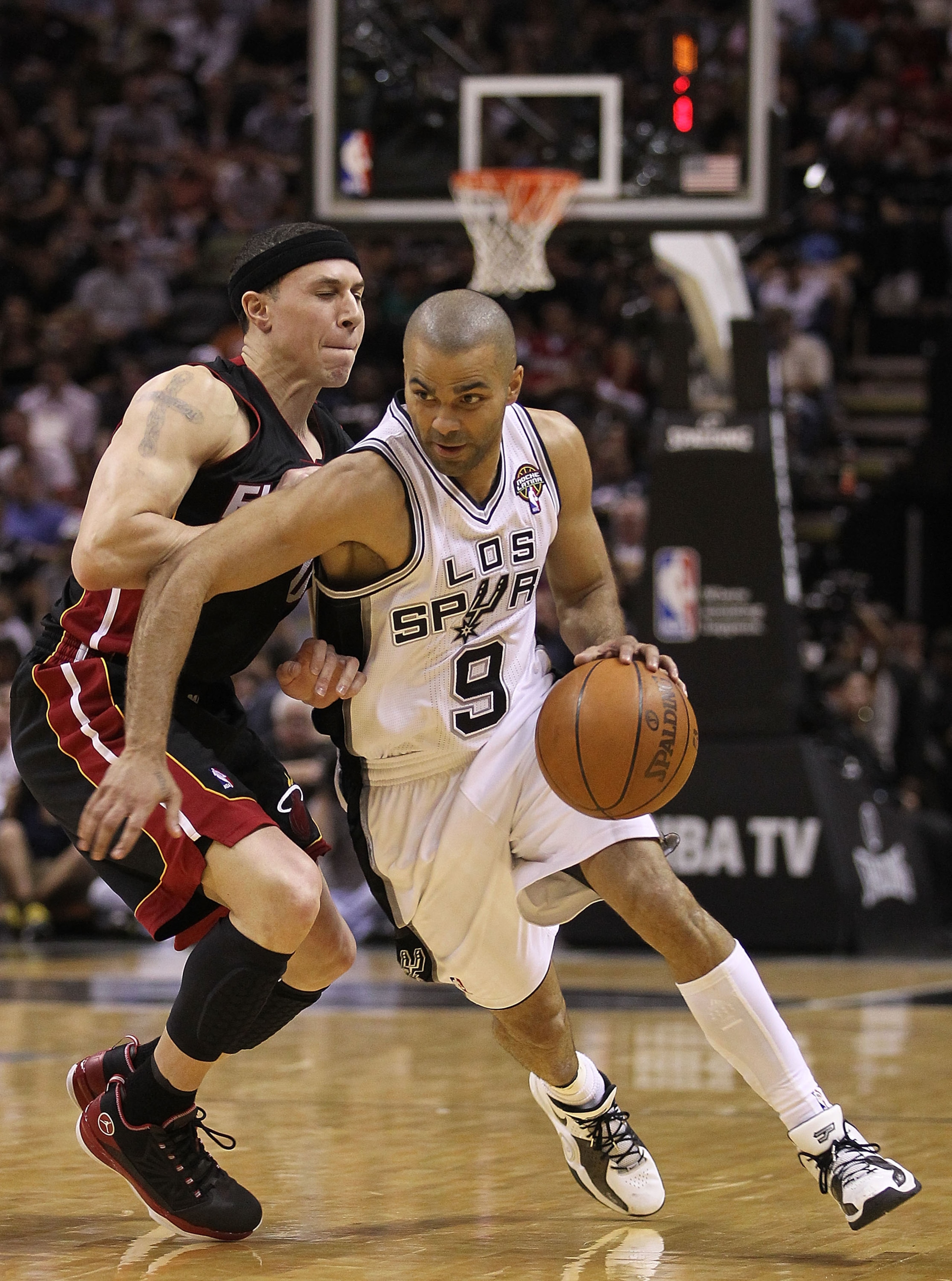 SAN ANTONIO, TX - MARCH 04: Guard Tony Parker #9 of the San Antonio Spurs dribbles the ball against Mike Bibby #0 of the Miami Heat at AT&T Center on March 4, 2011 in San Antonio, Texas. NOTE TO USER: User expressly acknowledges and agrees that, by dow SAN ANTONIO, TX - MARCH 04: Guard Tony Parker #9 of the San Antonio Spurs dribbles the ball against Mike Bibby #0 of the Miami Heat at AT&T Center on March 4, 2011 in San Antonio, Texas. NOTE TO USER: User expressly acknowledges and agrees that, by dow