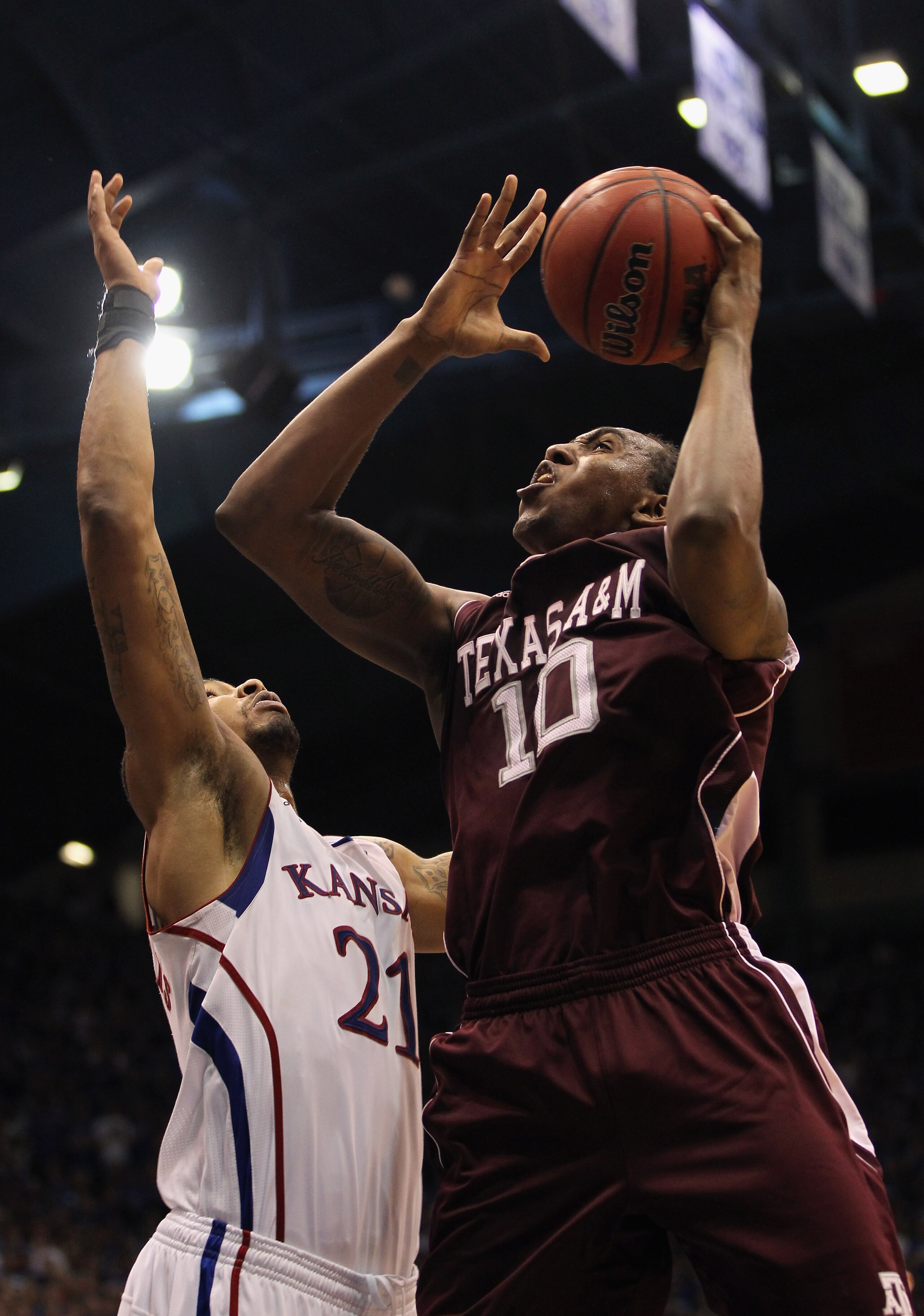 LAWRENCE, KS - MARCH 02:  David Loubeau #10 of the Texas A&M Aggies shoots over Markieff Morris #21 of the Kansas Jayhawks during the game on March 2, 2011 at Allen Fieldhouse in Lawrence, Kansas.  (Photo by Jamie Squire/Getty Images)