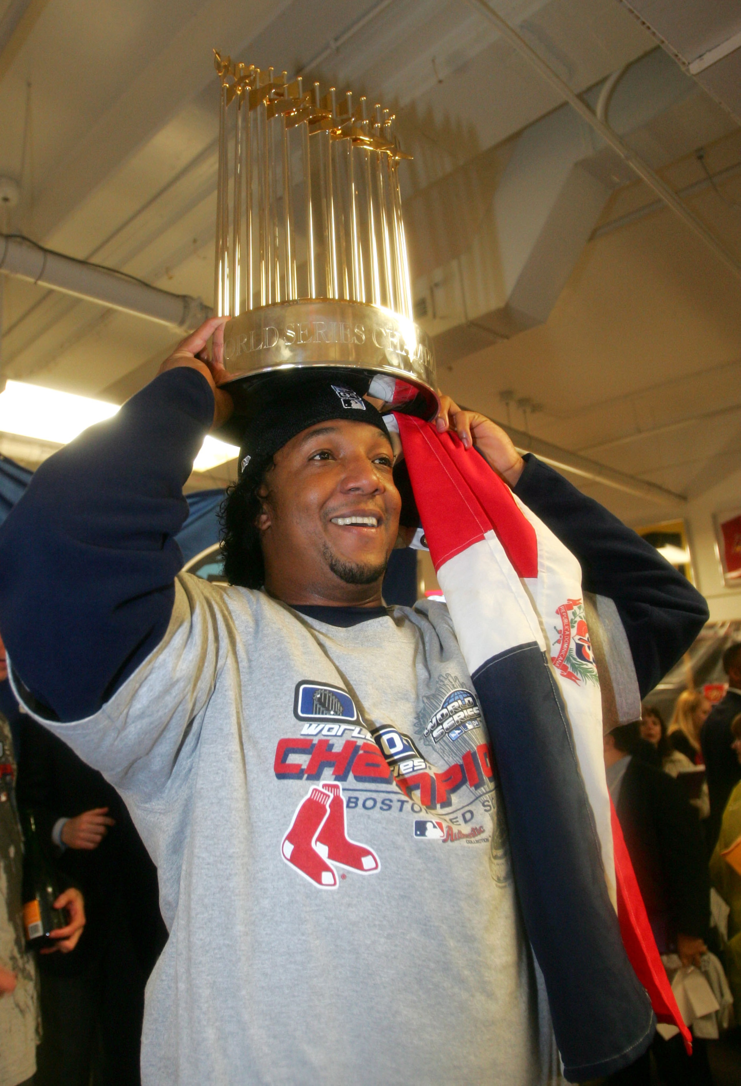 ST LOUIS - OCTOBER 27:  Pedro Martinez #45 of the Boston Red Sox celebrates with the Championship trophy after defeating the St. Louis Cardinals 3-0 to win game four of the World Series on October 27, 2004 at Busch Stadium in St. Louis, Missouri. (Photo b