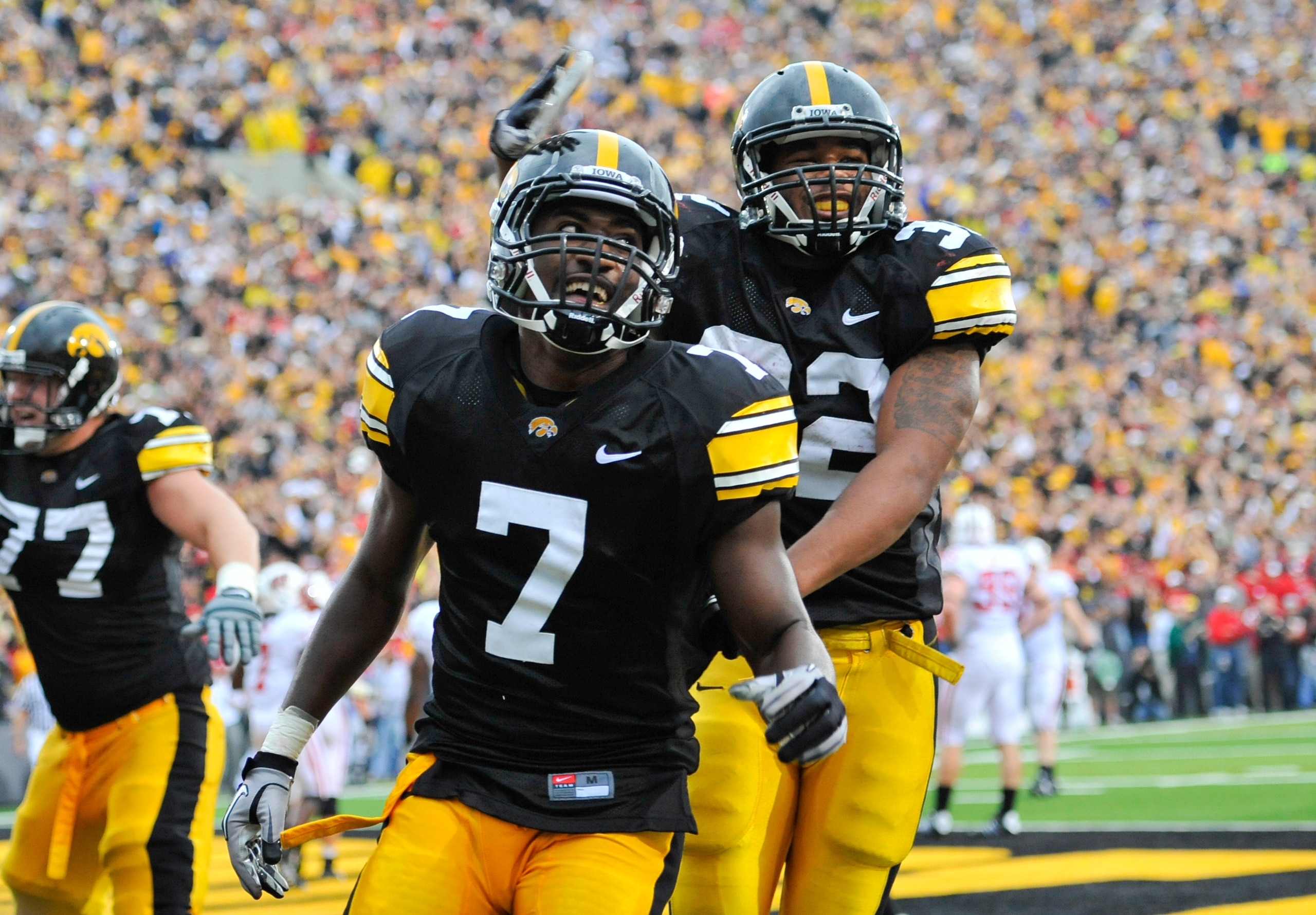 IOWA CITY, IA - OCTOBER 23- Wide receiver Marvin McNutt Jr. #7 of the University of Iowa Hawkeyes celebrates with teammate running back Adam Robinson #32 after scoring a touchdown against the Wisconsin Badgers during the second half of play at Kinnick Sta