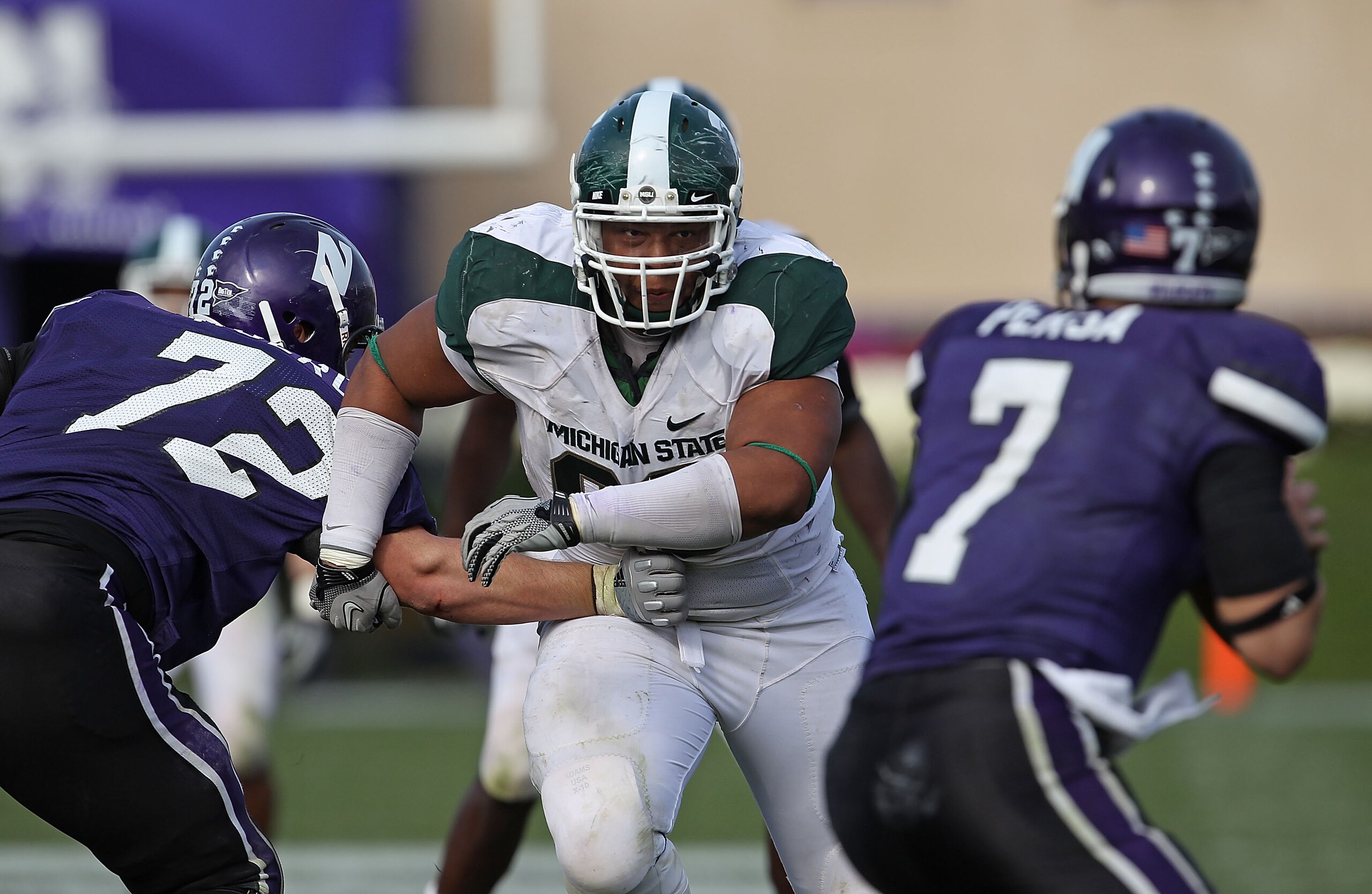 EVANSTON, IL - OCTOBER 23: Jerel Worthy #99 of the Michigan State Spartans moves past a block attempt by Brian Mulroe #72 of the Northwestern Wildcats with his sights set on Dan Persa #7 at Ryan Field on October 23, 2010 in Evanston, Illinois. Michigan St