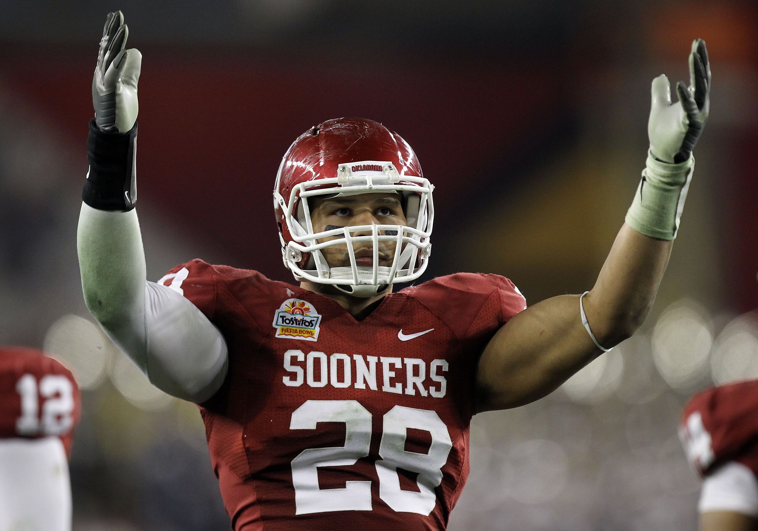 GLENDALE, AZ - JANUARY 01:  Travis Lewis #28 of the Oklahoma Sooners reacts at the end of the game against the Connecticut Huskies during the Tostitos Fiesta Bowl at the Universtity of Phoenix Stadium on January 1, 2011 in Glendale, Arizona.  (Photo by Ro