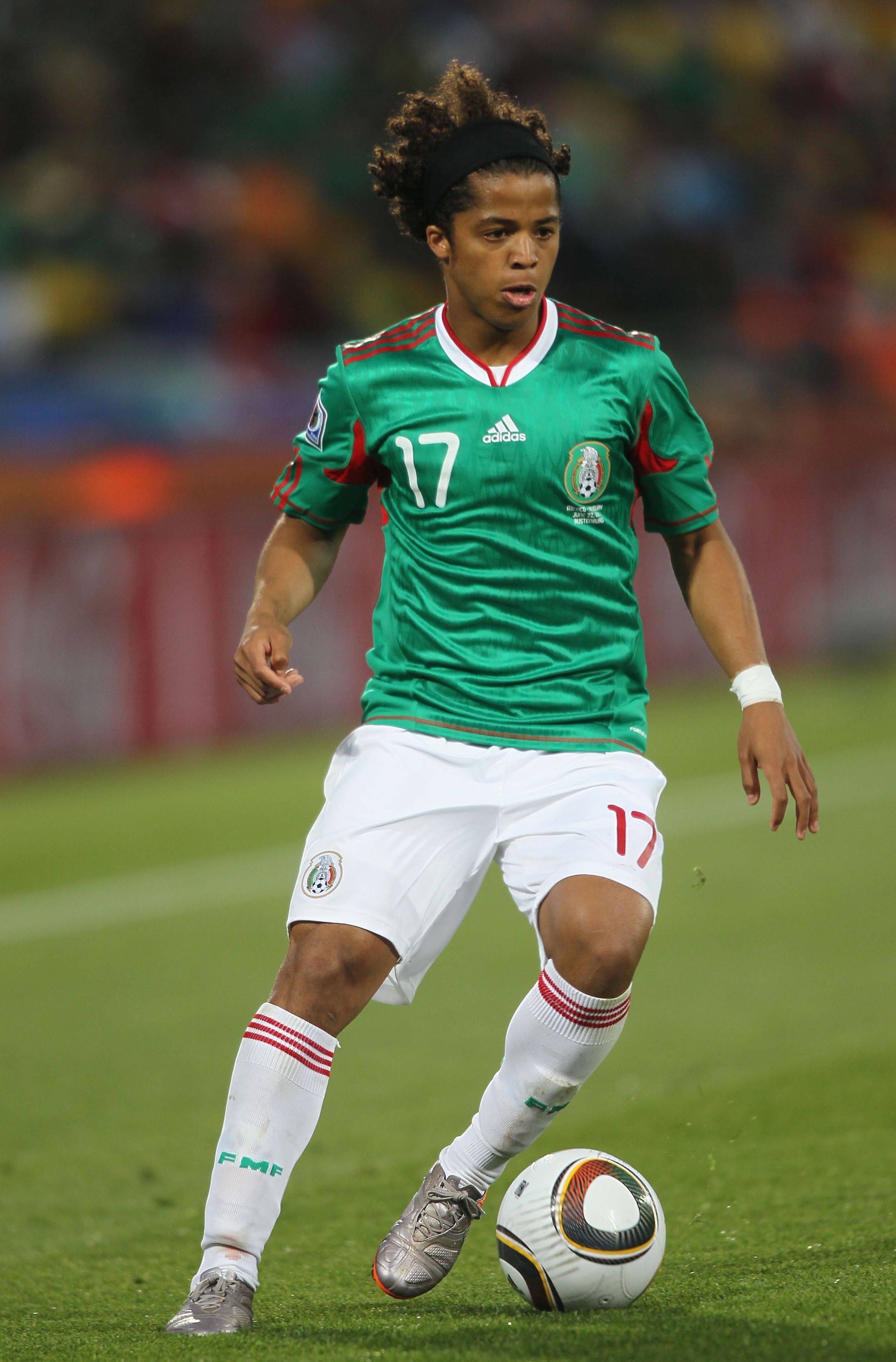 RUSTENBURG, SOUTH AFRICA - JUNE 22:  Giovani Dos Santos of Mexico runs with the ball during the 2010 FIFA World Cup South Africa Group A match between Mexico and Uruguay at the Royal Bafokeng Stadium on June 22, 2010 in Rustenburg, South Africa.  (Photo b