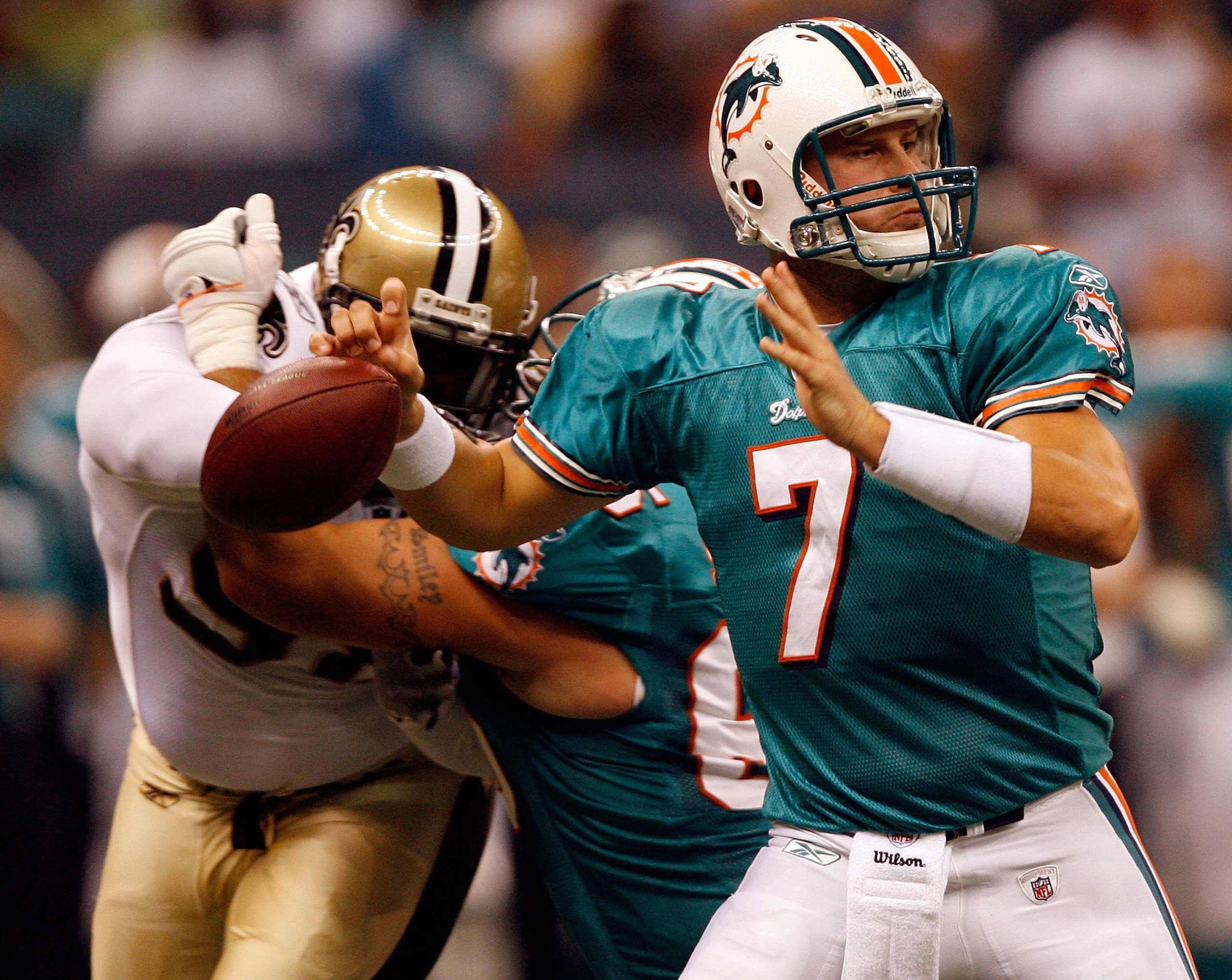NEW ORLEANS - AUGUST 28: Miami Dolphins Chad Henne #7 fumbles the ball after being stripped by New Orleans Saints defensive end Sedrick Ellis #98 during the second quarter of their final preseason game at the Louisiana Superdome on August 28, 2008 in New NEW ORLEANS - AUGUST 28: Miami Dolphins Chad Henne #7 fumbles the ball after being stripped by New Orleans Saints defensive end Sedrick Ellis #98 during the second quarter of their final preseason game at the Louisiana Superdome on August 28, 2008 in New