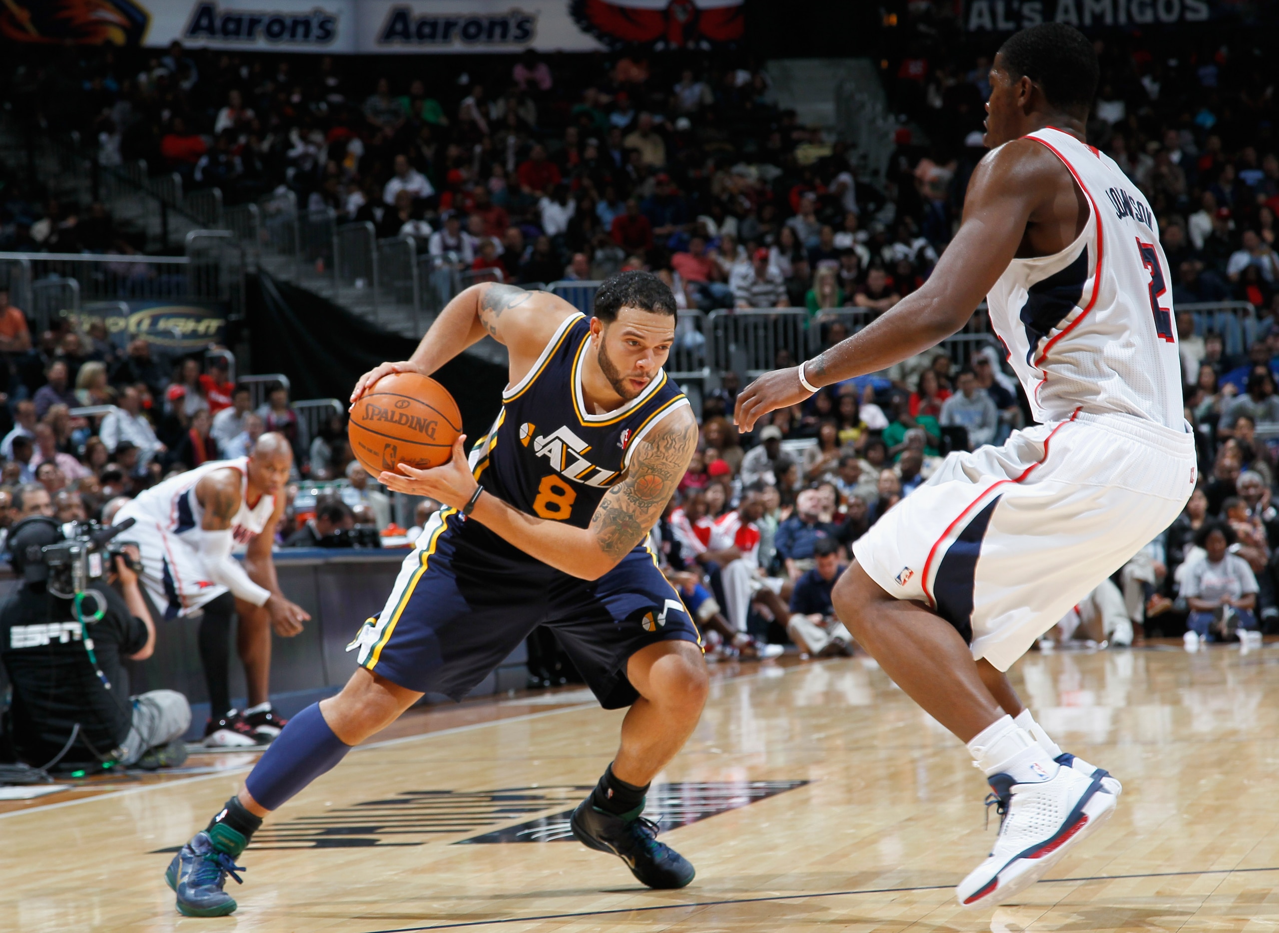 ATLANTA - NOVEMBER 12:  Deron Williams #8 of the Utah Jazz drives against Joe Johnson #2 of the Atlanta Hawks at Philips Arena on November 12, 2010 in Atlanta, Georgia.  NOTE TO USER: User expressly acknowledges and agrees that, by downloading and/or usin