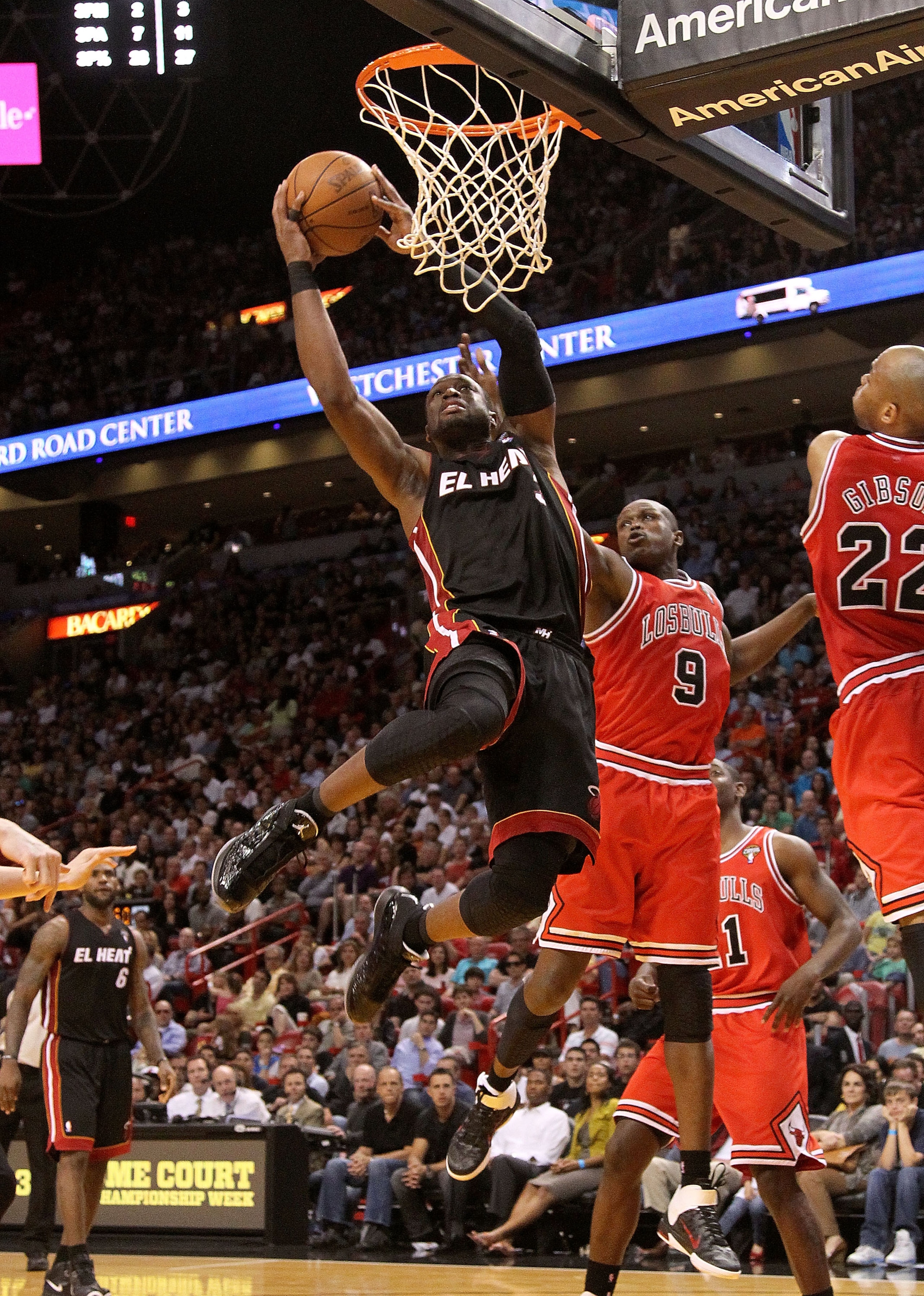 MIAMI, FL - MARCH 06:  Dwyane Wade #3 of the Miami Heat shoots over Luol Deng #9 of the Chicago Bulls during a game at American Airlines Arena on March 6, 2011 in Miami, Florida. NOTE TO USER: User expressly acknowledges and agrees that, by downloading an