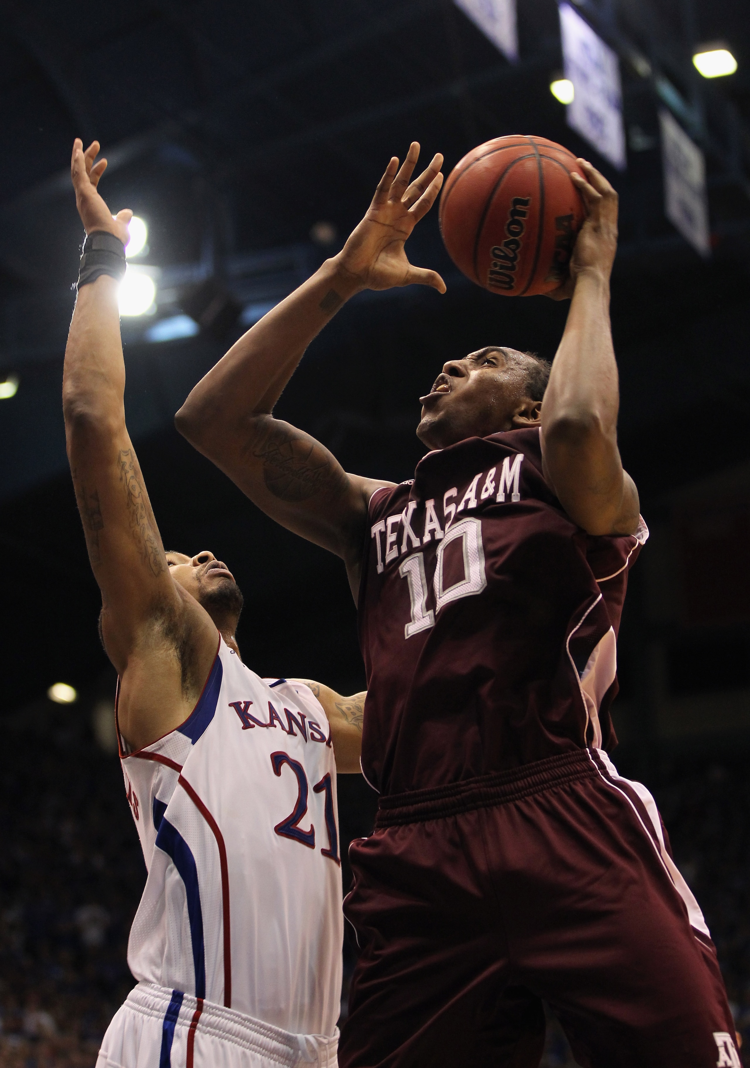 LAWRENCE, KS - MARCH 02: David Loubeau #10 of the Texas A&M Aggies shoots over Markieff Morris #21 of the Kansas Jayhawks during the game on March 2, 2011 at Allen Fieldhouse in Lawrence, Kansas. (Photo by Jamie Squire/Getty Images) LAWRENCE, KS - MARCH 02: David Loubeau #10 of the Texas A&M Aggies shoots over Markieff Morris #21 of the Kansas Jayhawks during the game on March 2, 2011 at Allen Fieldhouse in Lawrence, Kansas. (Photo by Jamie Squire/Getty Images)