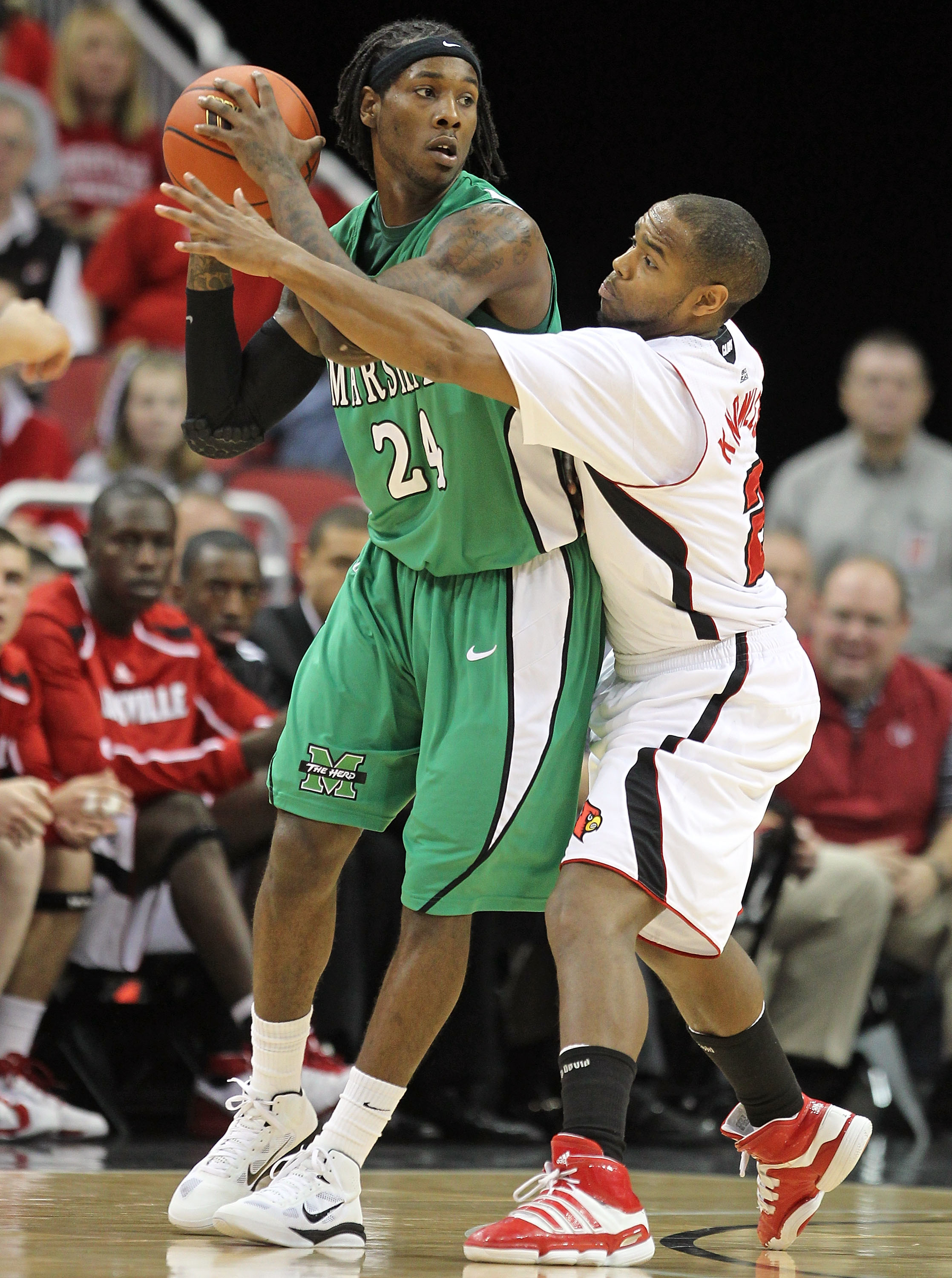 LOUISVILLE, KY - NOVEMBER 27: Preston Knowles #2 of the Louisville Cardinals defends DeAndre Kane #24 of the Marshall Thundering Herd during the game at the KFC Yum! Center on November 27, 2010 in Louisville, Kentucky. Louisville won 80-66. (Photo by An