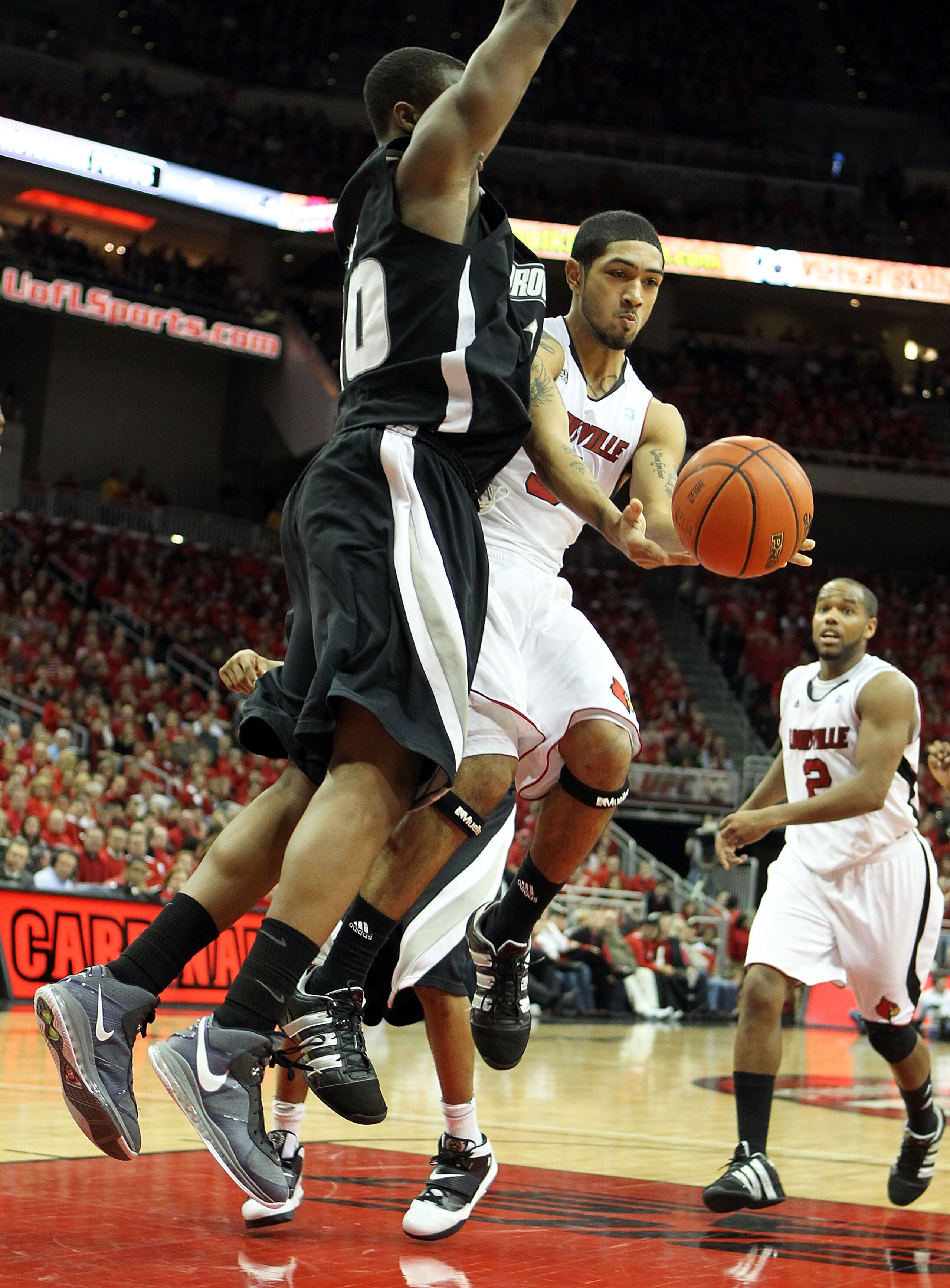 LOUISVILLE, KY - MARCH 02: Peyton Siva #3 of the Louisville Cardinals passes the ball while defended by Kadeem Batts #10 of the Providence Friars during the Big East Conference game at the KFC Yum! Center on March 2, 2011 in Louisville, Kentucky. Louis LOUISVILLE, KY - MARCH 02: Peyton Siva #3 of the Louisville Cardinals passes the ball while defended by Kadeem Batts #10 of the Providence Friars during the Big East Conference game at the KFC Yum! Center on March 2, 2011 in Louisville, Kentucky. Louis