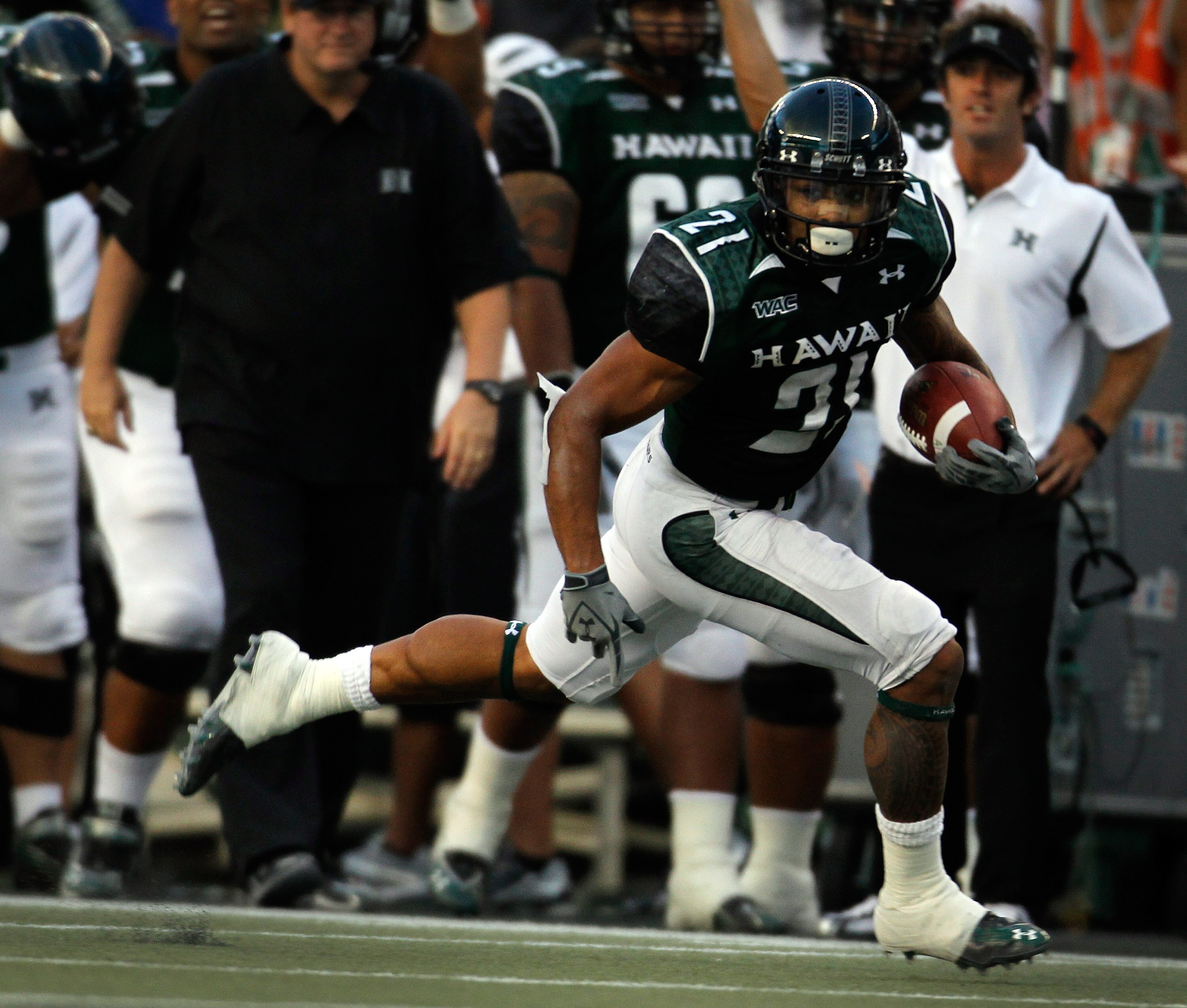 HONOLULU - SEPTEMBER 2:  Kealoha Pilares #21 of the University of Hawaii Warriors runs towards the end zone for a touchdown during first half action against the University of Southern California Trojans at Aloha Stadium September 2, 2010 in Honolulu, Hawa