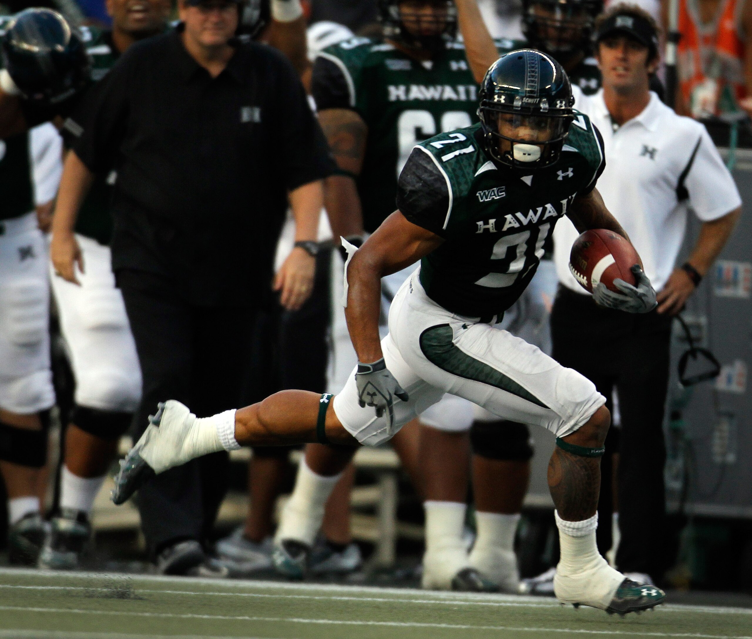 HONOLULU - SEPTEMBER 2:  Kealoha Pilares #21 of the University of Hawaii Warriors runs towards the end zone for a touchdown during first half action against the University of Southern California Trojans at Aloha Stadium September 2, 2010 in Honolulu, Hawa