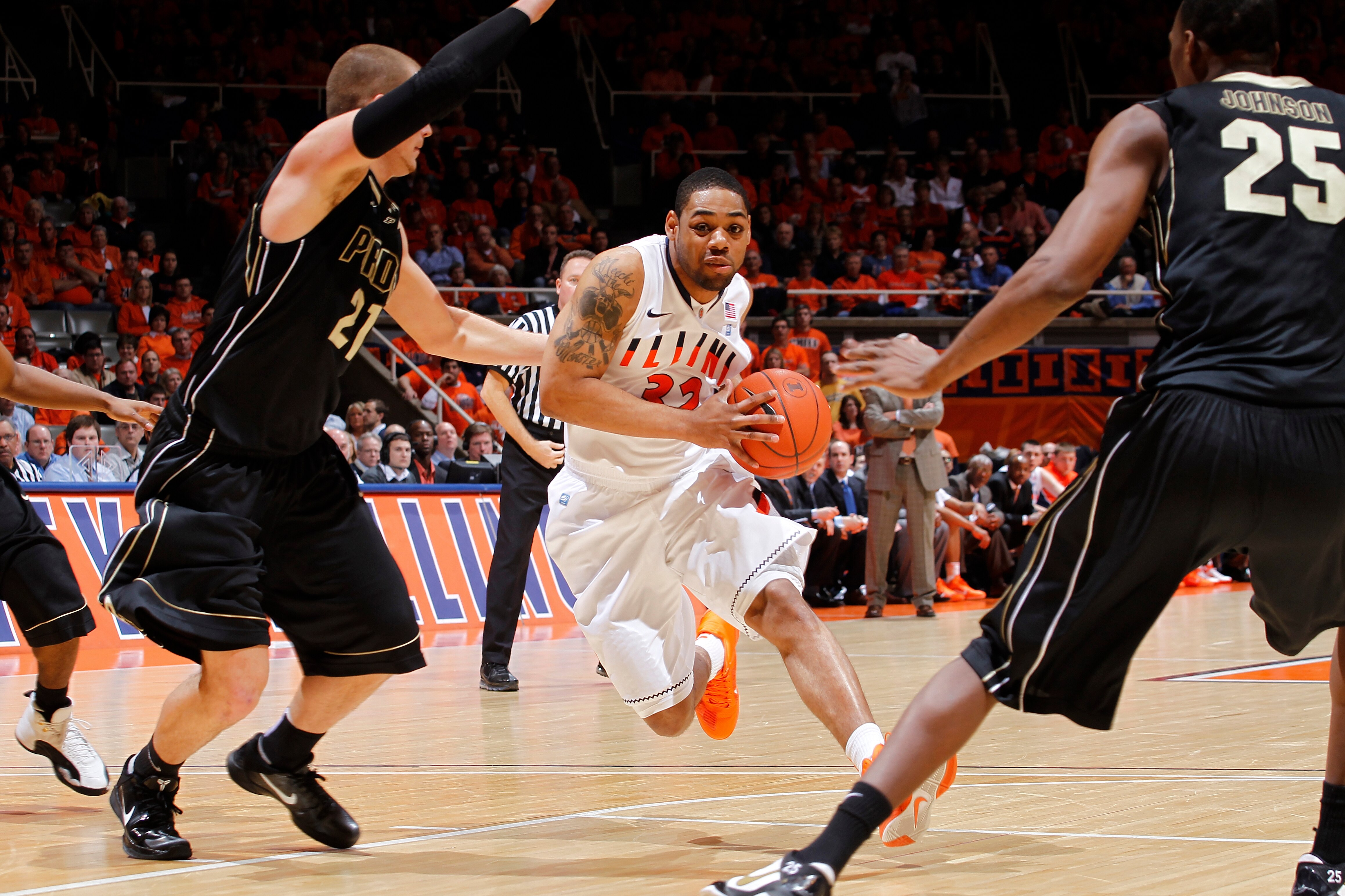 CHAMPAIGN, IL - FEBRUARY 13: Demetri McCamey #32 of the Illinois Fighting Illini goes to the basket against the Purdue Boilermakers at Assembly Hall on February 13, 2011 in Champaign, Illinois. Purdue defeated Illinois 81-70. (Photo by Joe Robbins/Getty I
