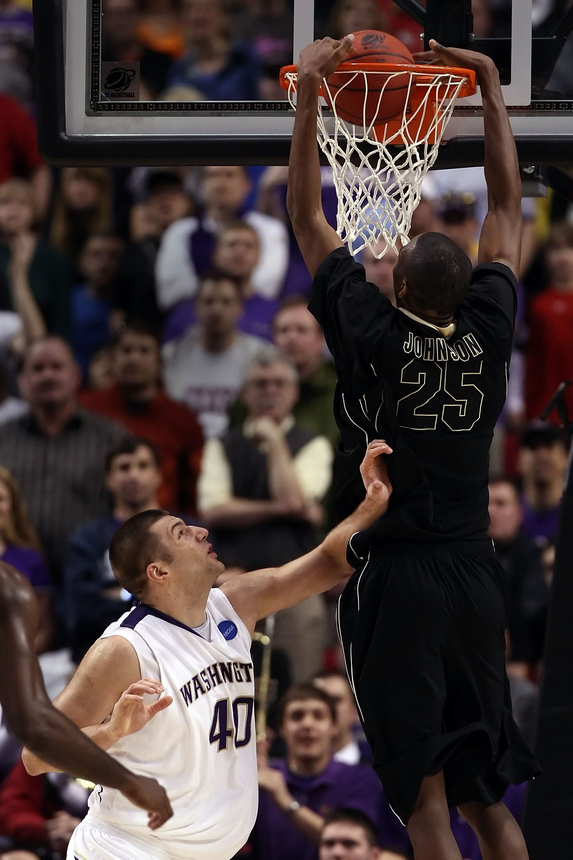 PORTLAND, OR - MARCH 21:  JaJuan Johnson #25 of the Purdue Boilermakers dunks the ball over Jon Brockman #40 of the Washington Huskies in the first half during the second round of the NCAA Division I Men's Basketball Tournament at the Rose Garden on March