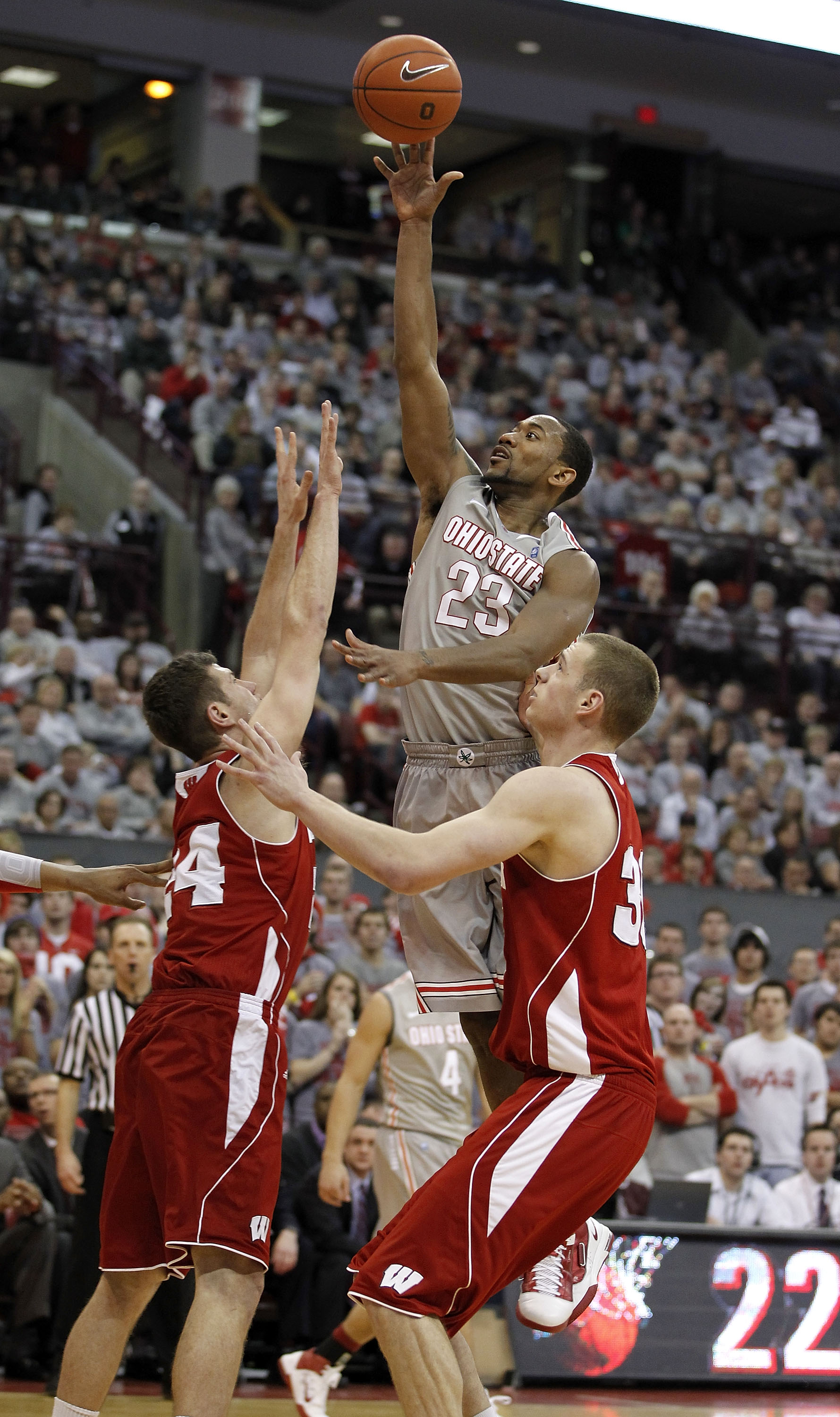 COLUMBUS, OH - MARCH 06:  David Lighty #23 of the Ohio State Buckeyes shoots over Tim Jarmusz #24 and Jon Leuer #30 of the Wisconsin Badgers on March 6, 2011 at the Value City Arena in Columbus, Ohio. Ohio State won the game 93-65. (Photo by Gregory Shamu