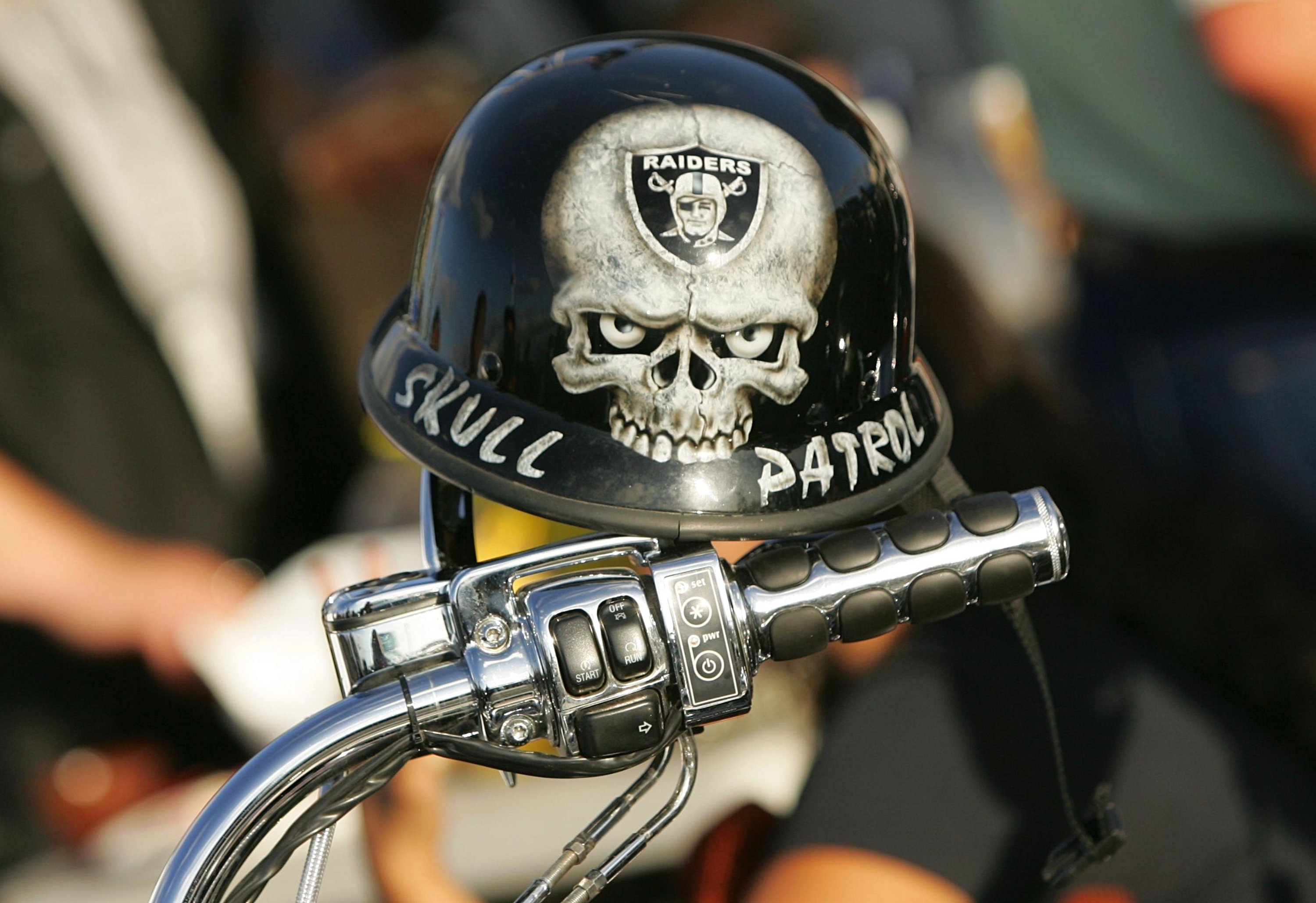 OAKLAND, CA - SEPTEMBER 14:  A mini biker helmet with a Oakland Raiders logo is seen on the handle bar of a motorcycle in the parking lot outside Oakland-Alameda County Coliseum prior to the Raiders playing against the San Diego Chargers against the Oakla