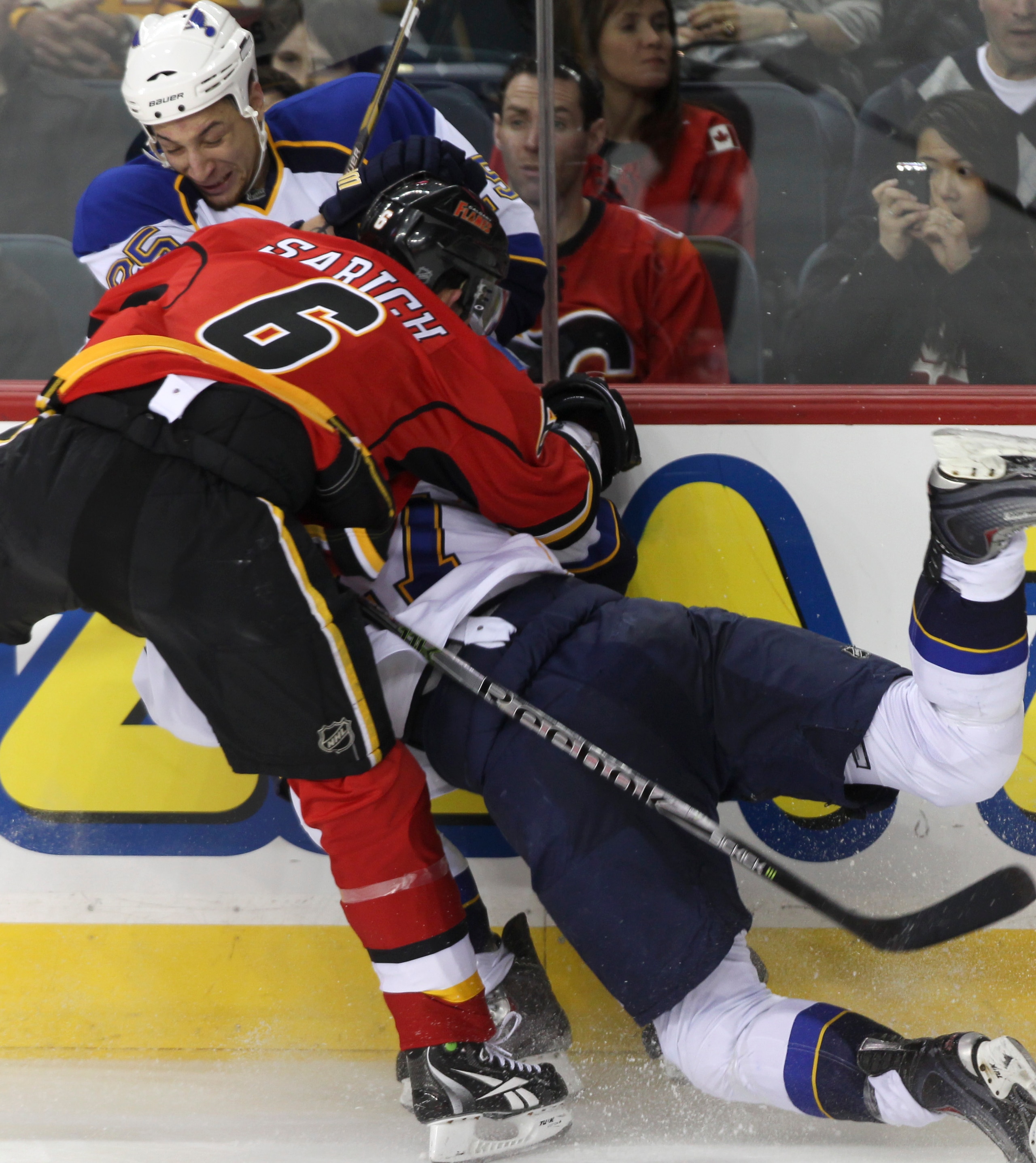 CALGARY, AB - FEBRUARY 27: Cory Sarich #6 of the Calgary Flames takes out Chris Stewart #25 and Alex Pietrangelo #27 of the St. Louis Blues in the second period of NHL action on February 27, 2011 at the Scotiabank Saddledome in Calgary, Alberta, Canada. ( CALGARY, AB - FEBRUARY 27: Cory Sarich #6 of the Calgary Flames takes out Chris Stewart #25 and Alex Pietrangelo #27 of the St. Louis Blues in the second period of NHL action on February 27, 2011 at the Scotiabank Saddledome in Calgary, Alberta, Canada. (