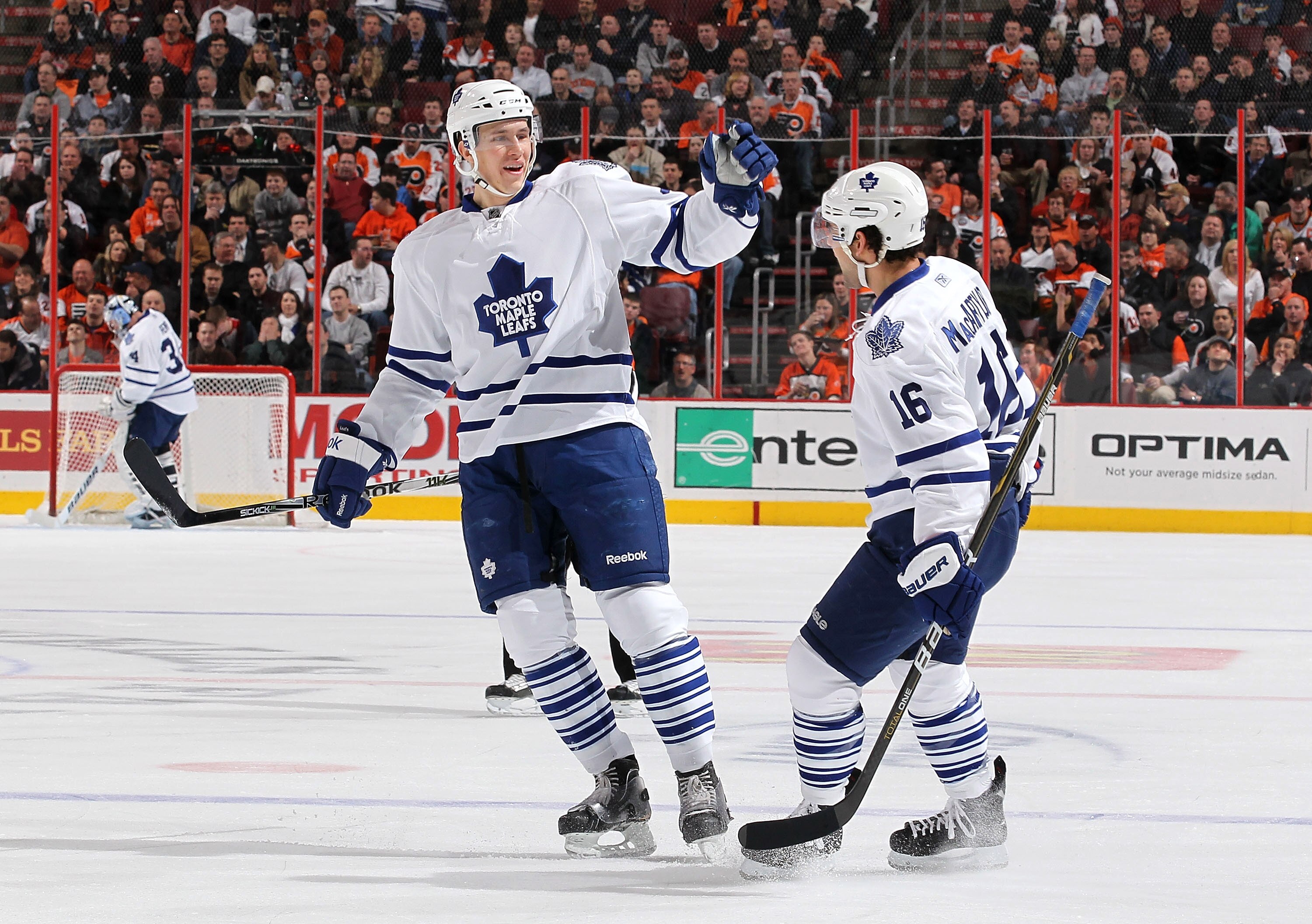 PHILADELPHIA - MARCH 03:  Keith Aulie #59 of the Toronto Maple Leafs celebrates a goal by Clarke MacArthur #16 of The Philadelphia Flyers during their game on March 3, 2011 at The Wells Fargo Center in Philadelphia, Pennsylvania.  (Photo by Al Bello/Getty
