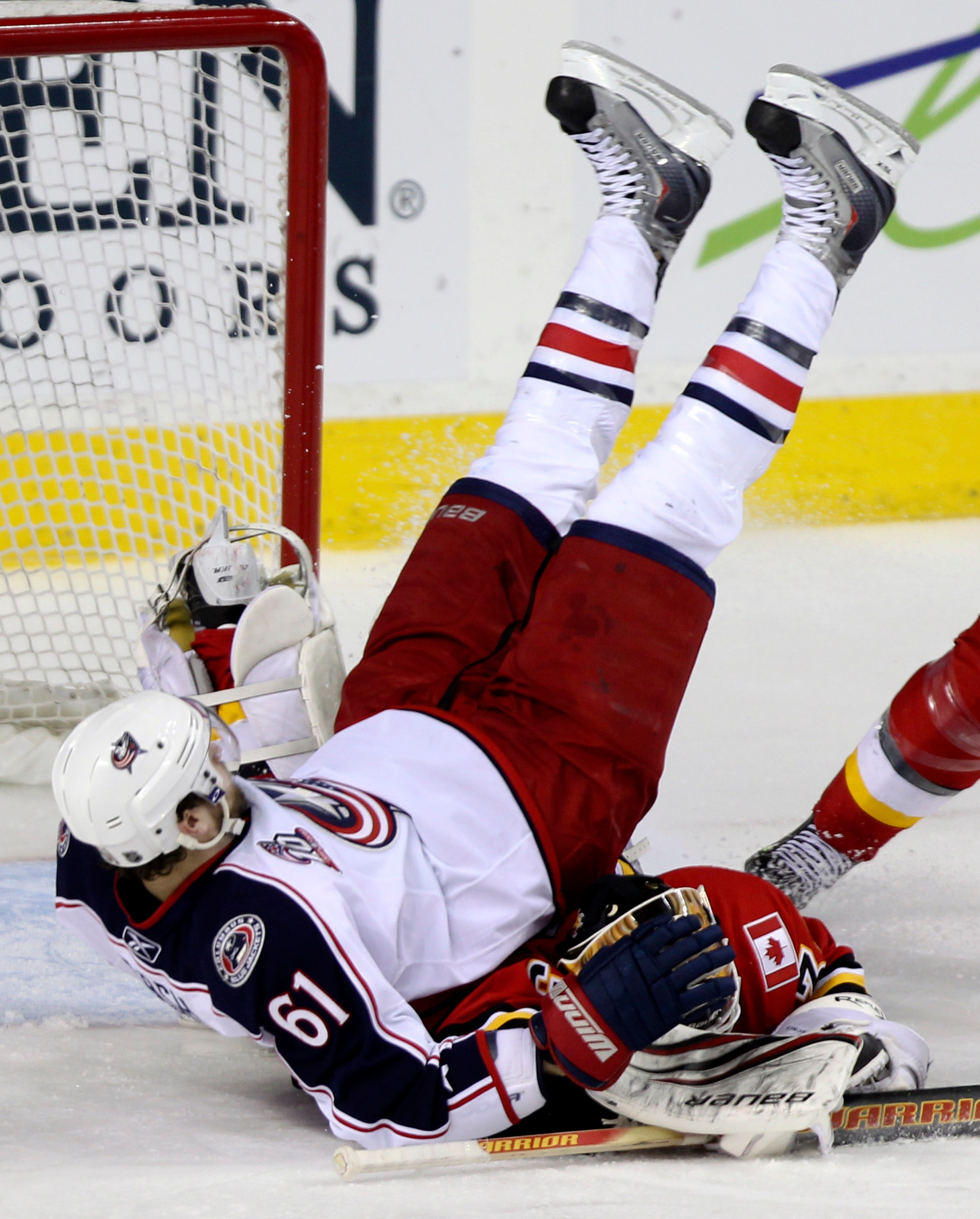 CALGARY, AB - MARCH 4: Rick Nash #51 of the Columbus Blue Jackets takes a goaltender interference penalty for flying over goalie Miikka Kiprusoff #34 of the Calgary Flames in the third period of NHL action on March 4, 2011 at the Scotiabank Saddledome in CALGARY, AB - MARCH 4: Rick Nash #51 of the Columbus Blue Jackets takes a goaltender interference penalty for flying over goalie Miikka Kiprusoff #34 of the Calgary Flames in the third period of NHL action on March 4, 2011 at the Scotiabank Saddledome in