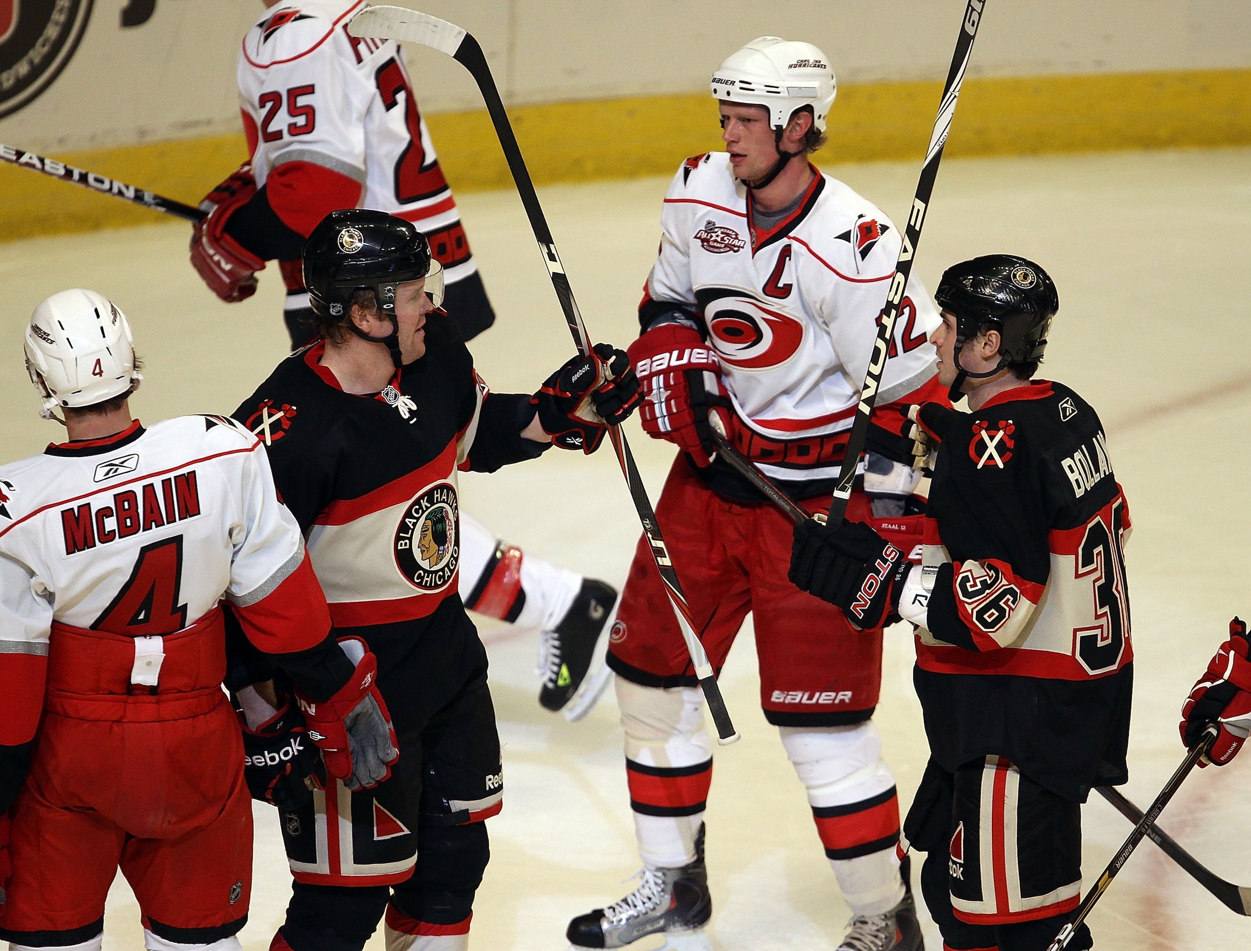 CHICAGO, IL - MARCH 04: Bryan Bickell #29 and Dave Bolland #36 of the Chicago Blackhawks celebrate Bickell's 1st period goal next to Jamie McBain #4 and Eric Staal #12 of the Carolina Hurricanes at the United Center on March 4, 2011 in Chicago, Illinois. CHICAGO, IL - MARCH 04: Bryan Bickell #29 and Dave Bolland #36 of the Chicago Blackhawks celebrate Bickell's 1st period goal next to Jamie McBain #4 and Eric Staal #12 of the Carolina Hurricanes at the United Center on March 4, 2011 in Chicago, Illinois.