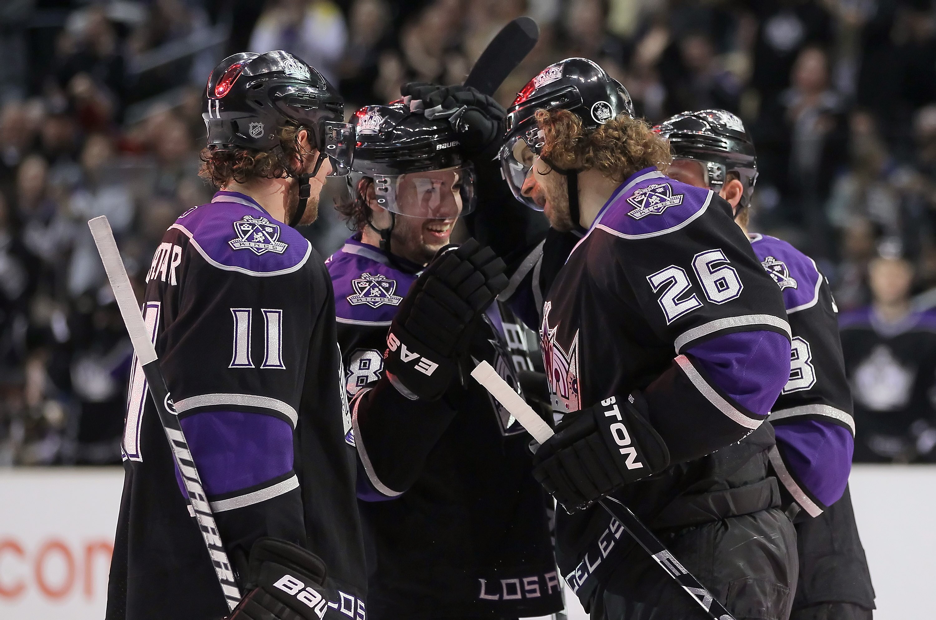 LOS ANGELES, CA - FEBRUARY 26:  (L-R) Anze Kopitar #11, Drew Doughty #8 and Michal Handzus #26 of the Los Angeles Kings celebrate Doughty's second period goal against the Colorado Avalanche at Staples Center on February 26, 2011 in Los Angeles, California