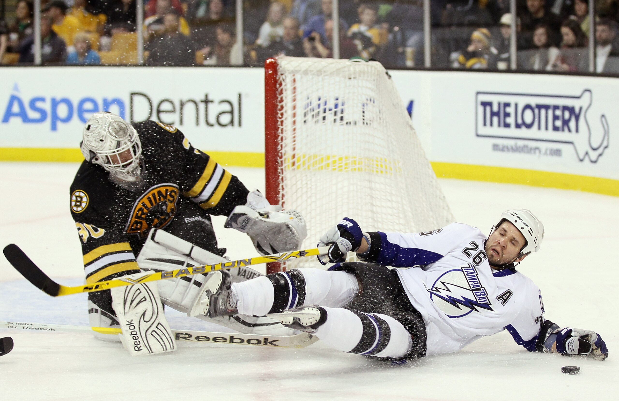 BOSTON, MA - MARCH 03: Tim Thomas #30 of the Boston Bruins stops a shot as Martin St. Louis #26 of the Tampa Bay Lightning runs into him in the second period on March 3, 2011 at the TD Garden in Boston, Massachusetts. (Photo by Elsa/Getty Images) BOSTON, MA - MARCH 03: Tim Thomas #30 of the Boston Bruins stops a shot as Martin St. Louis #26 of the Tampa Bay Lightning runs into him in the second period on March 3, 2011 at the TD Garden in Boston, Massachusetts. (Photo by Elsa/Getty Images)