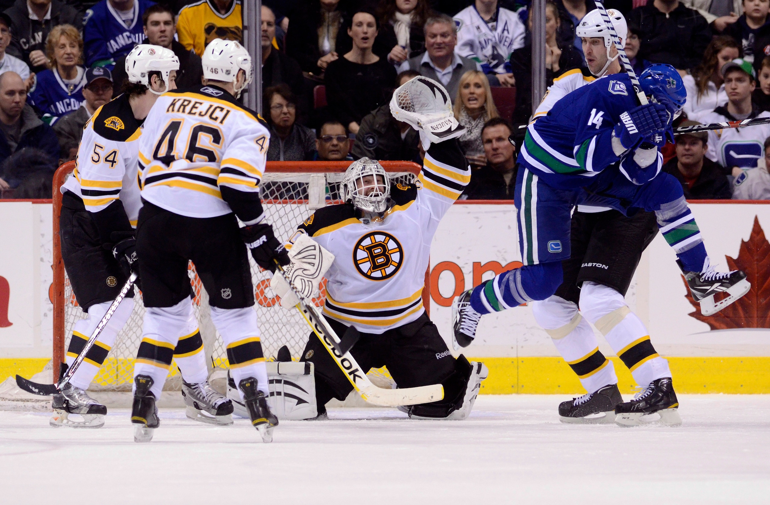 VANCOUVER, CANADA - FEBRUARY 26: Alexandre Burrows #14 of the Vancouver Canucks jumps out of the way of a shot as the puck sails over the head of goalie Tim Thomas #30 of the Boston Bruins during the third period in NHL action on February 26, 2011 at Roge VANCOUVER, CANADA - FEBRUARY 26: Alexandre Burrows #14 of the Vancouver Canucks jumps out of the way of a shot as the puck sails over the head of goalie Tim Thomas #30 of the Boston Bruins during the third period in NHL action on February 26, 2011 at Roge