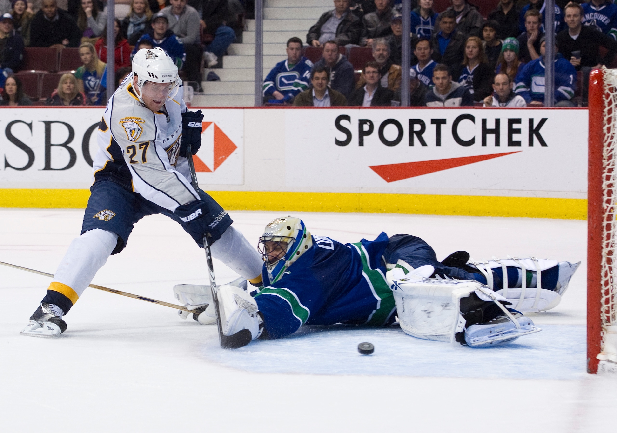 VANCOUVER, CANADA - MARCH 3: Patric Hornqvist #27 of the Nashville Predators slides the puck past goalie Roberto Luongo #1 of the Vancouver Canucks during the third period in NHL action on March 03, 2011 at Rogers Arena in Vancouver, British Columbia, Can VANCOUVER, CANADA - MARCH 3: Patric Hornqvist #27 of the Nashville Predators slides the puck past goalie Roberto Luongo #1 of the Vancouver Canucks during the third period in NHL action on March 03, 2011 at Rogers Arena in Vancouver, British Columbia, Can