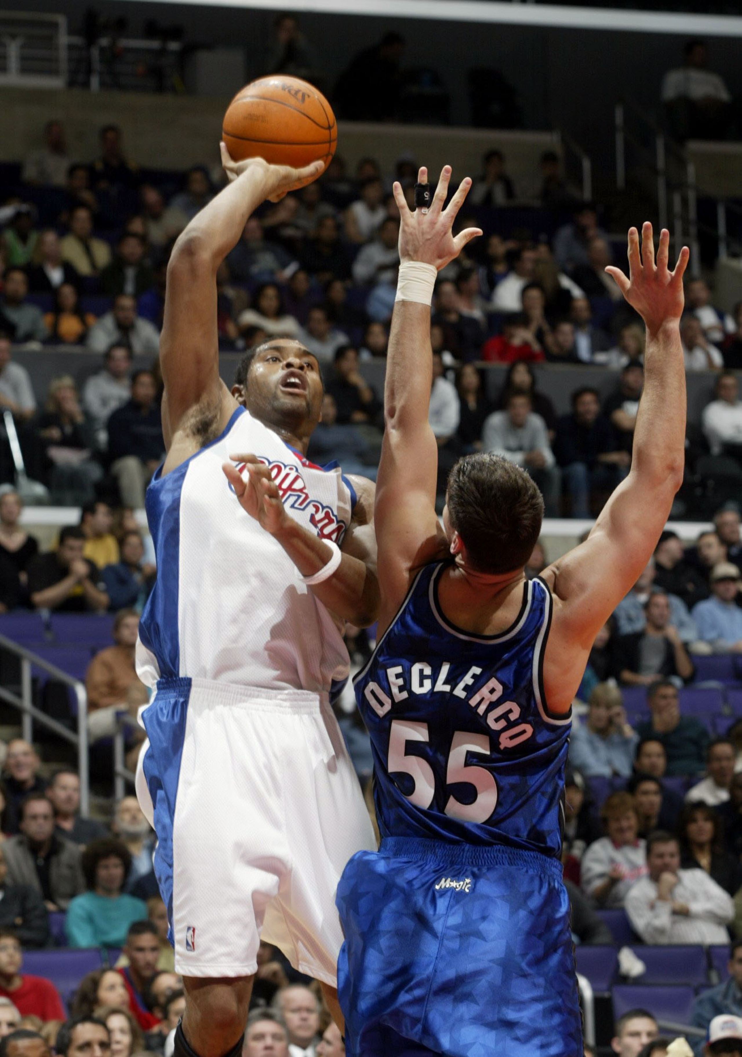 LOS ANGELES - NOVEMBER 14:   Michael Olowokandi #34 of the Los Angeles Clippers shoots over Andrew DeClercq #55 of the Orlando Magic on November 14, 2002 at Staples Center in Los  Angeles, California.  NOTE TO USER:  User expressly acknowledges and agrees