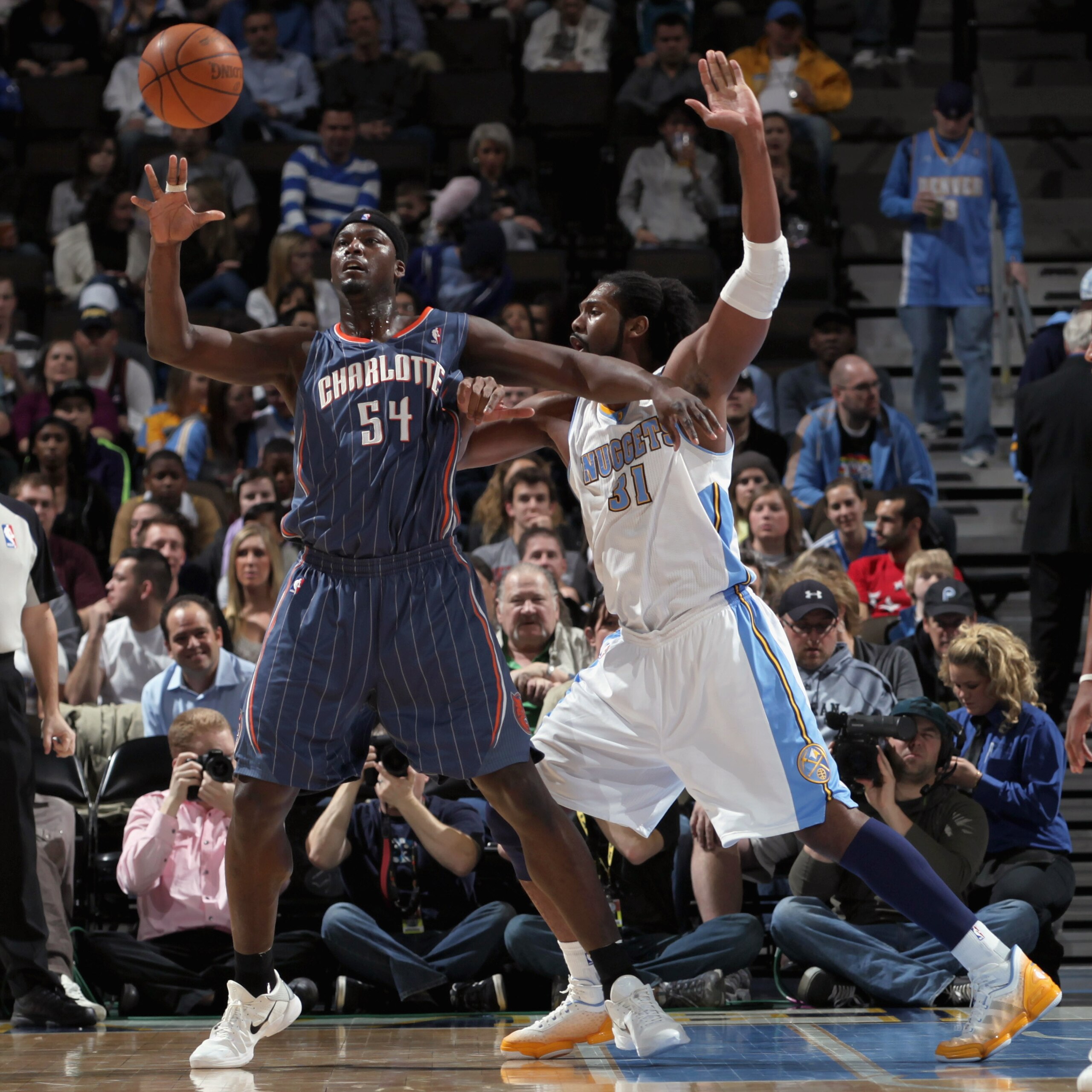 DENVER, CO - MARCH 02:  Kwame Brown #54 of the Charlotte Bobcats collects the ball against the defense of Nene #31 of the Denver Nuggets at the Pepsi Center on March 2, 2011 in Denver, Colorado. NOTE TO USER: User expressly acknowledges and agrees that, b