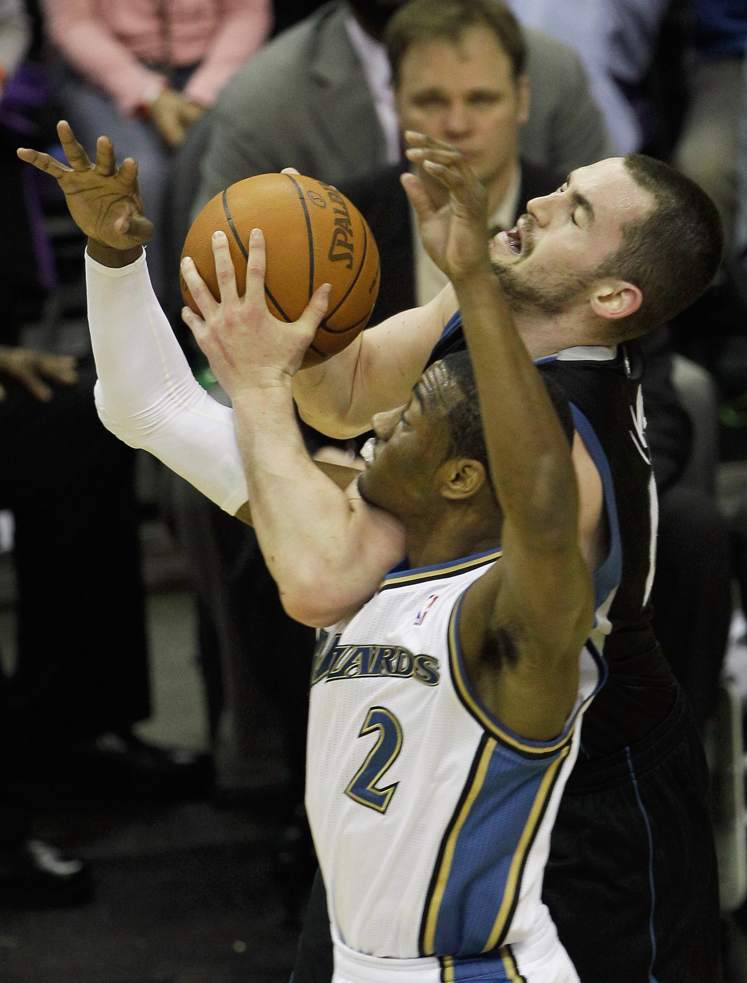 WASHINGTON, DC - MARCH 05:  John Wall #2 of the Washington Wizards fouls Kevin Love #42 of the Minnesota Timberwolves at the Verizon Center on March 5, 2011 in Washington, DC. NOTE TO USER: User expressly acknowledges and agrees that, by downloading and/o