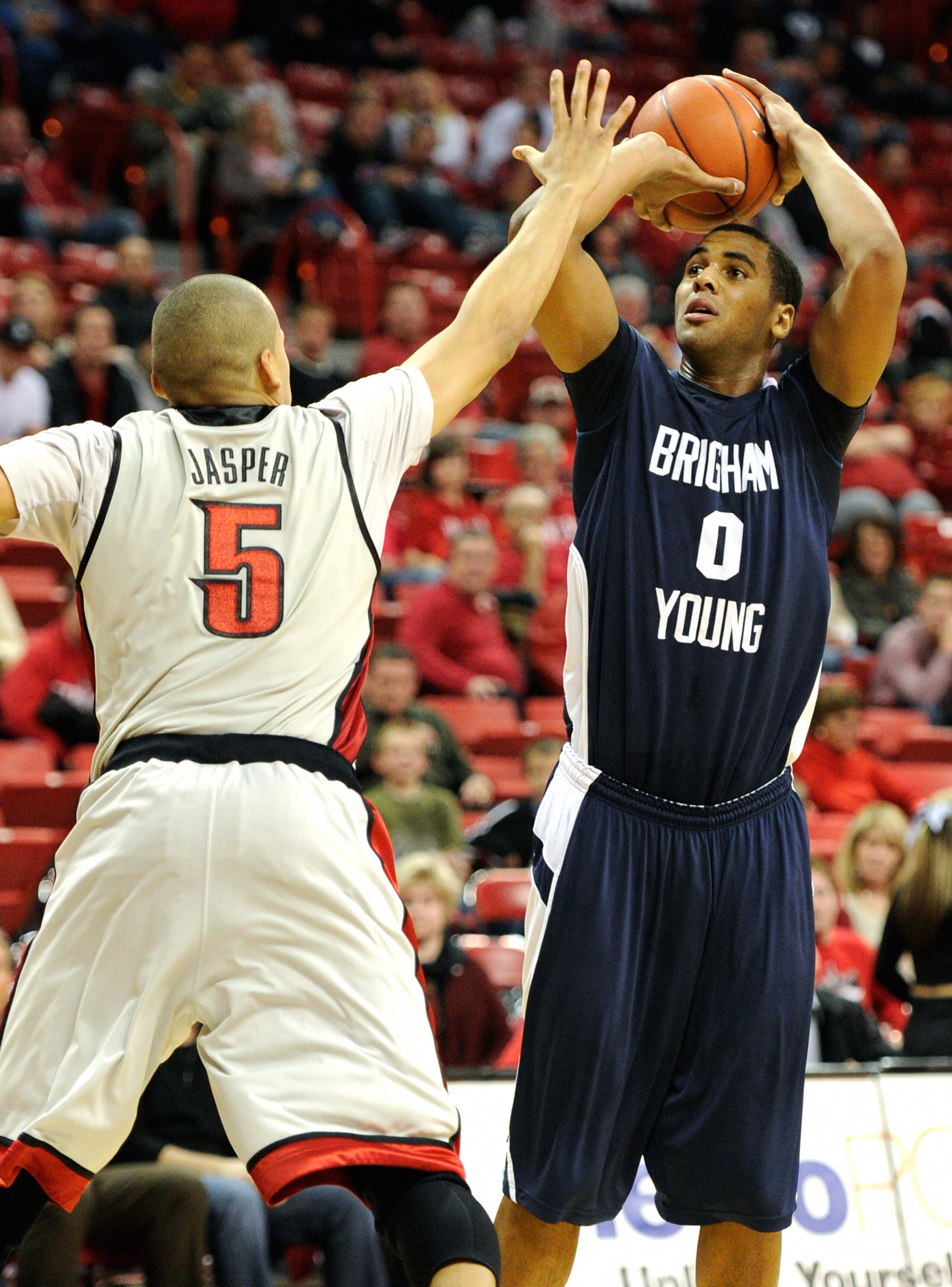 LAS VEGAS, NV - JANUARY 05: Brandon Davies #0 of the Brigham Young University Cougars shoots against Derrick Jasper #5 of the UNLV Rebels during their game at the Thomas & Mack Center January 5, 2011 in Las Vegas, Nevada. BYU won 89-77. (Photo by Ethan LAS VEGAS, NV - JANUARY 05: Brandon Davies #0 of the Brigham Young University Cougars shoots against Derrick Jasper #5 of the UNLV Rebels during their game at the Thomas & Mack Center January 5, 2011 in Las Vegas, Nevada. BYU won 89-77. (Photo by Ethan
