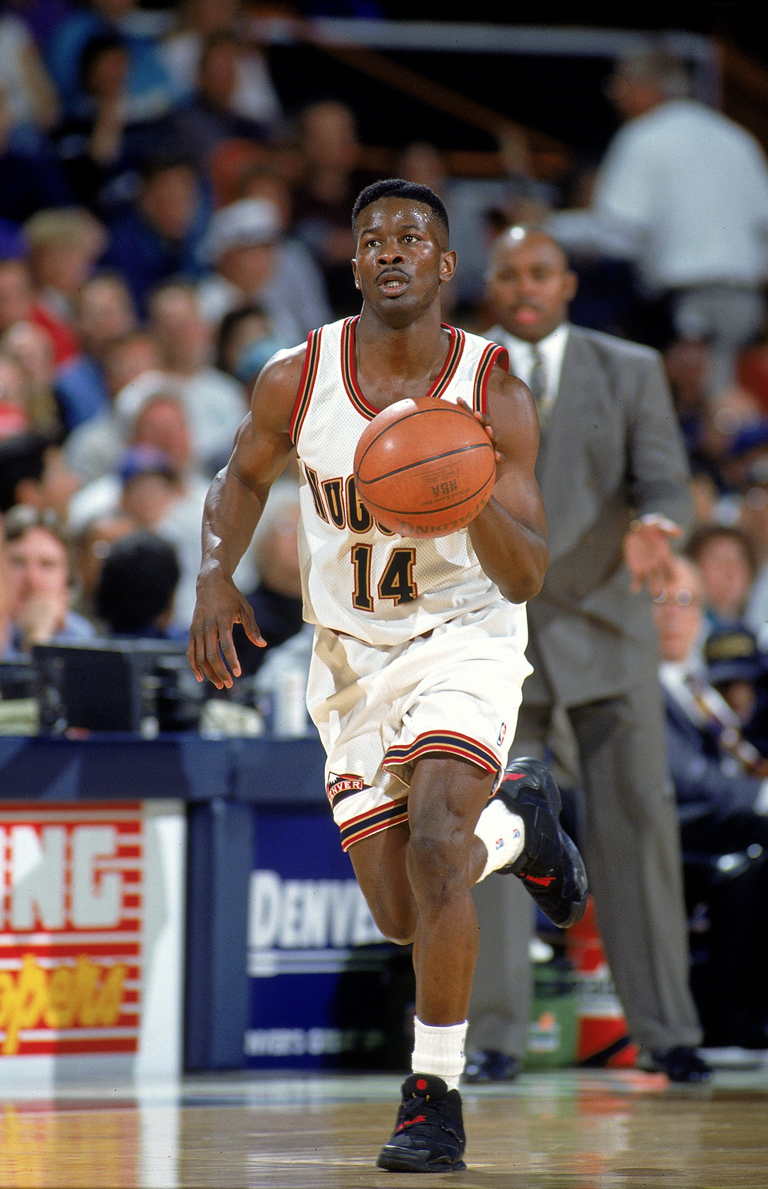 Robert Pack #14 of the Denver Nuggets dribbles the ball during a game against the Minnesota Timberwolves.
