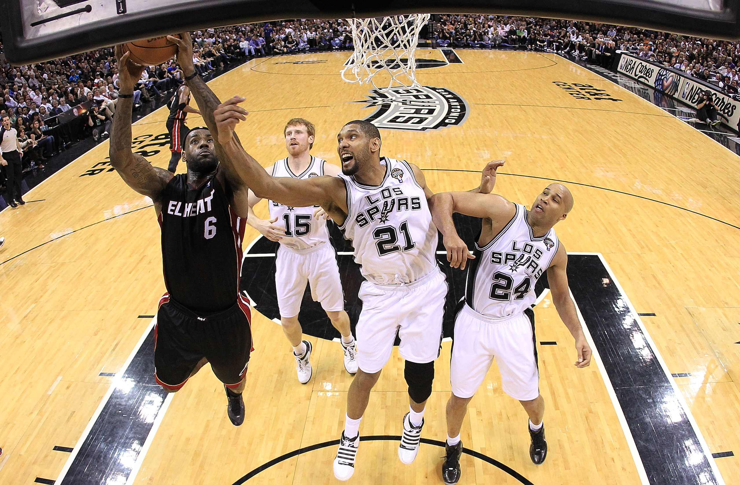 SAN ANTONIO, TX - MARCH 04:  Forward LeBron James #6 of the Miami Heat takes a shot against Tim Duncan #21 of the San Antonio Spurs at AT&T Center on March 4, 2011 in San Antonio, Texas.   NOTE TO USER: User expressly acknowledges and agrees that, by down