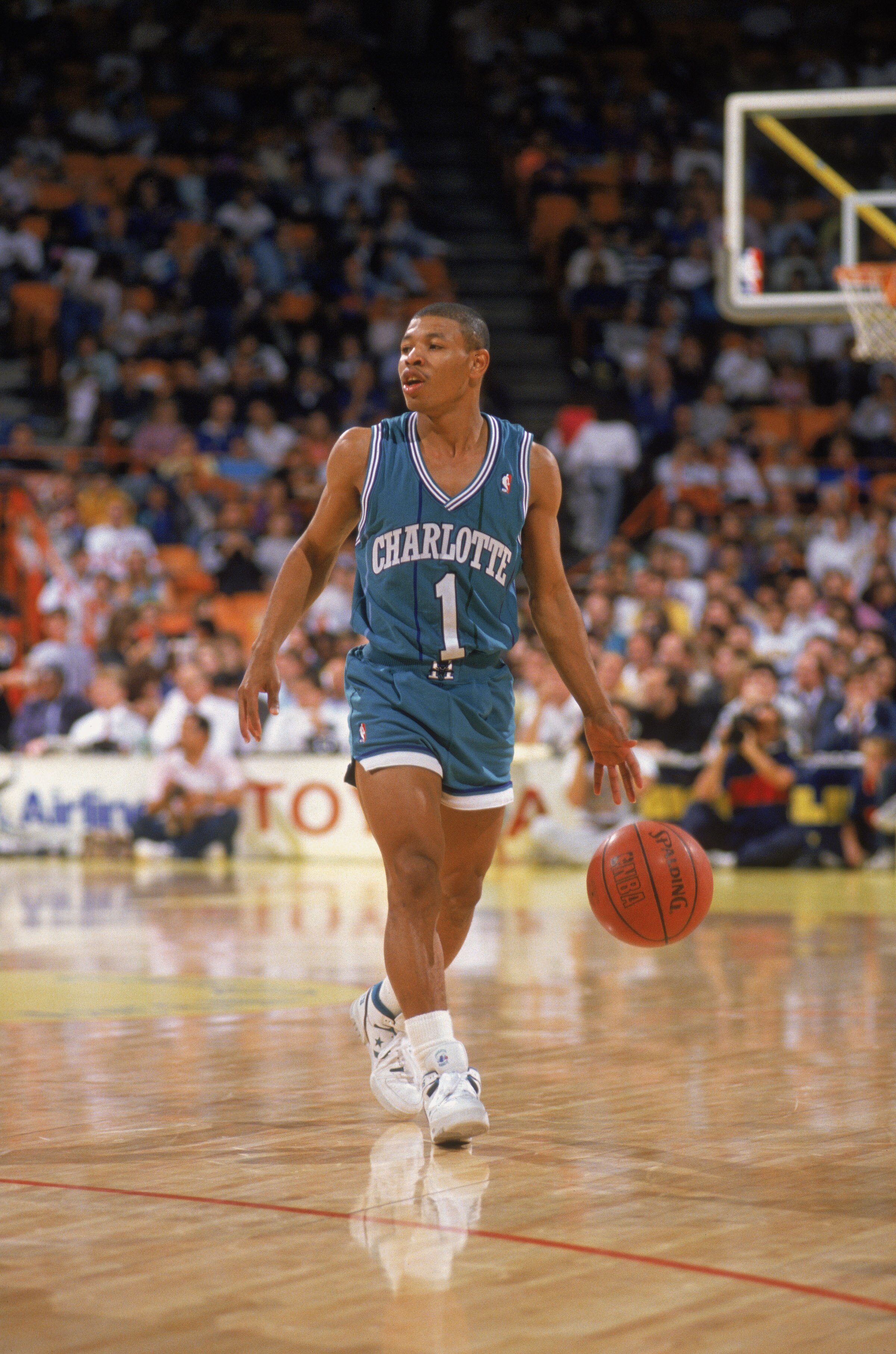 CHARLOTTE, NC - 1989:  Mugsy Bogues #1 of the Charlotte Hornets dribbles the ball during an NBA game at Charlotte Colesium in 1989. (Photo by Rick Stewart/Getty Images)