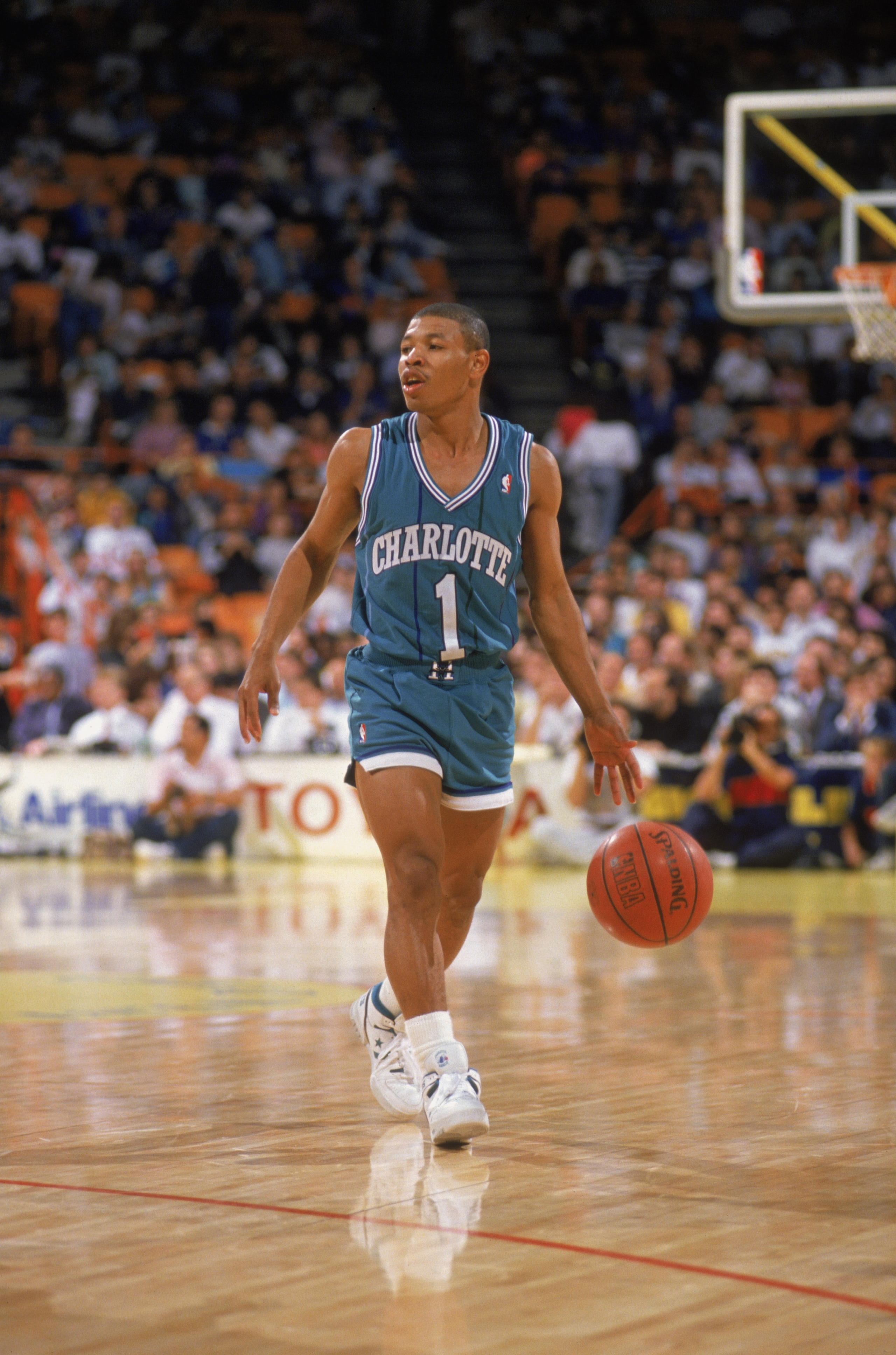 CHARLOTTE, NC - 1989:  Mugsy Bogues #1 of the Charlotte Hornets dribbles the ball during an NBA game at Charlotte Colesium in 1989. (Photo by Rick Stewart/Getty Images)