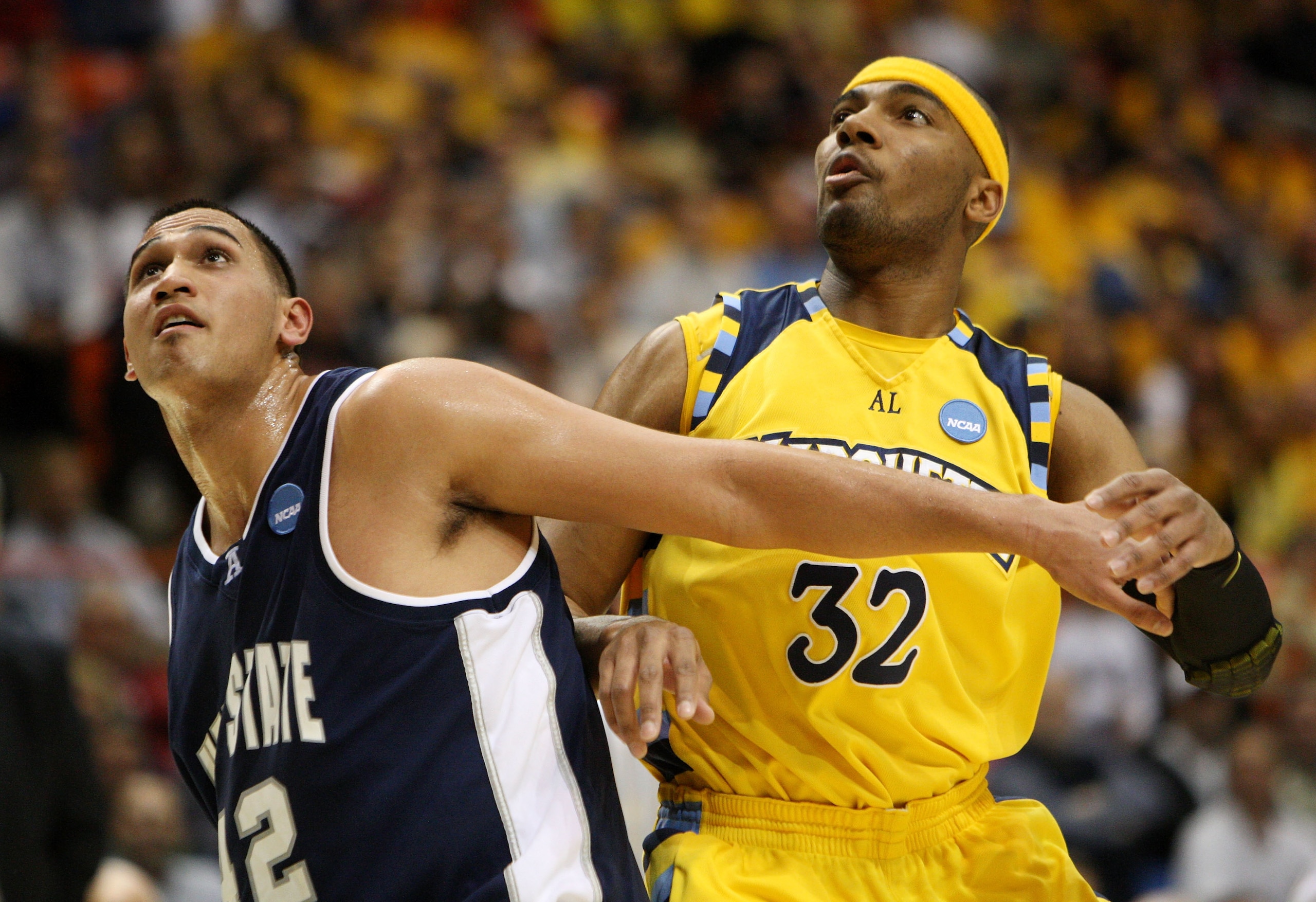 BOISE, ID - MARCH 20:  Forward Lazar Hayward #32 of the Marquette Golden Eagles fights for position with forward Tai Wesley #42 of the Utah State Aggies in the first round of the NCAA Division I Men's Basketball Tournament at the Taco Bell Arena on March