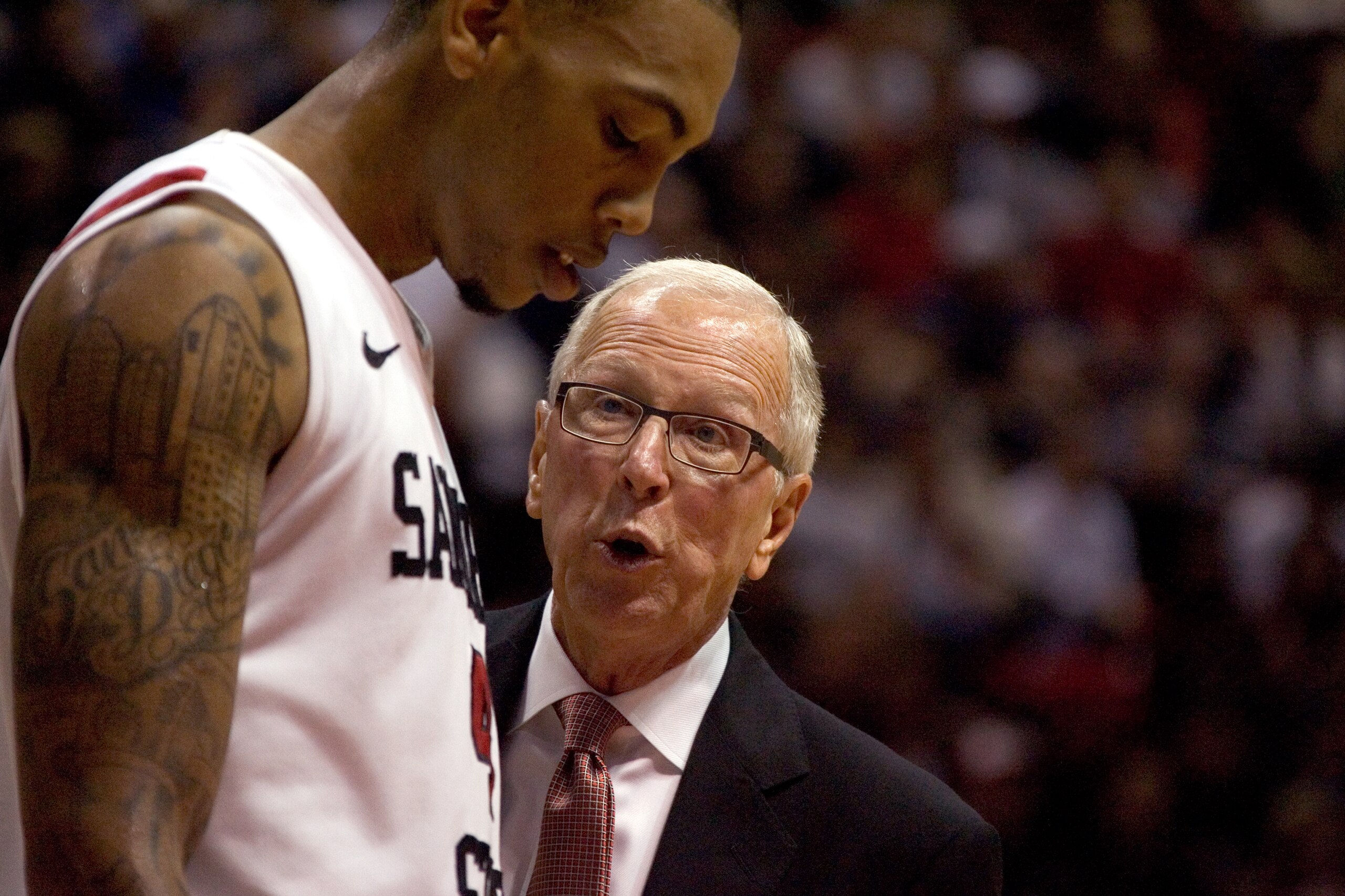 SAN DIEGO, CA - FEBRUARY 26:  Coach Steve Fisher (R) speaks with Malcolm Thomas #4 of the San Diego State Aztecs during a time out against the Brigham Young Cougars during the second half at Cox Arena on February 26, 2011 in San Diego, California. (Photo