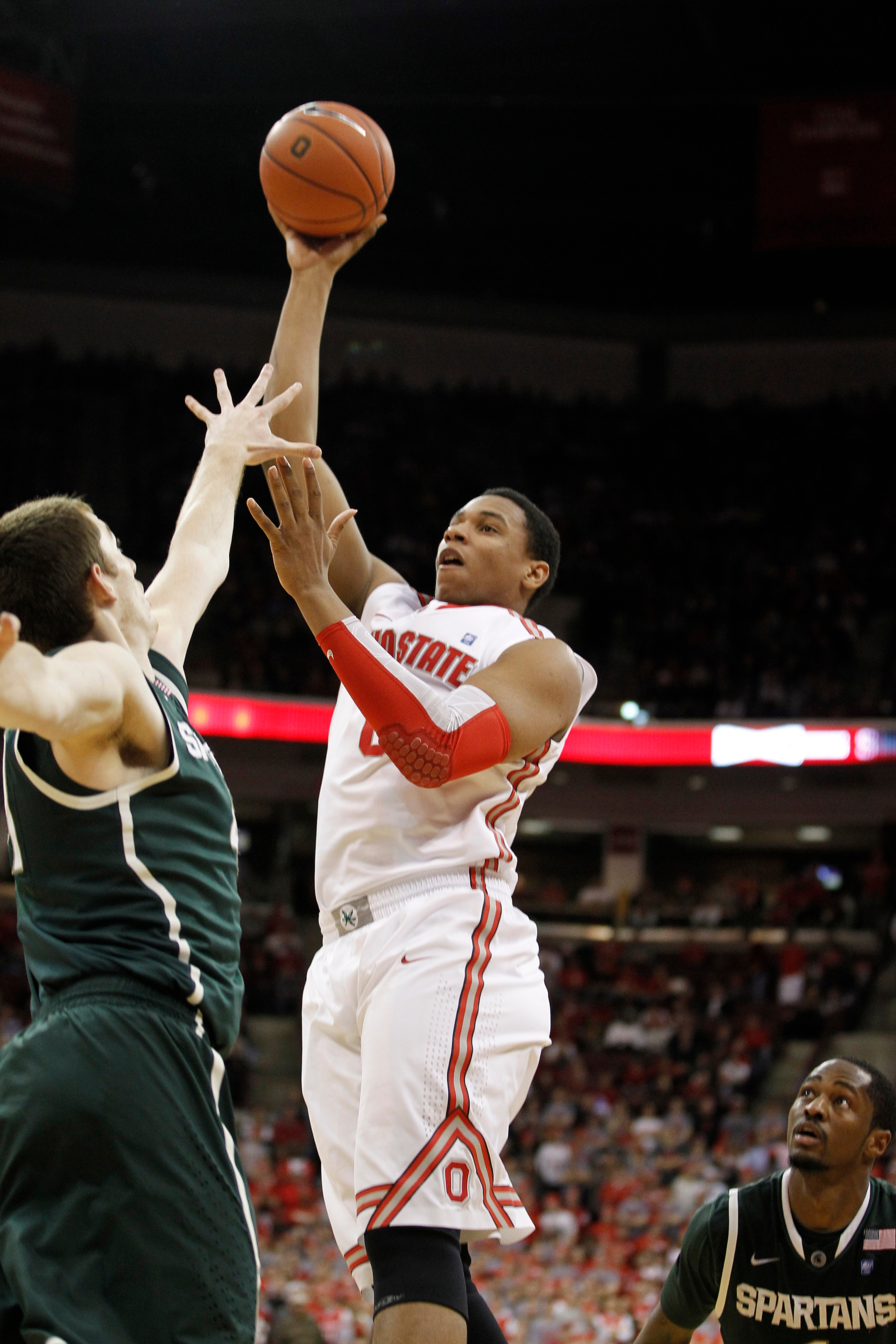 COLUMBUS, OH - FEBRUARY 15:  Jared Sullinger #0 of the Ohio State Buckeyes gets a shot off while playing the Michigan State Spartans on February 15, 2011 at Value City Arena in Columbus, Ohio.  (Photo by Gregory Shamus/Getty Images)