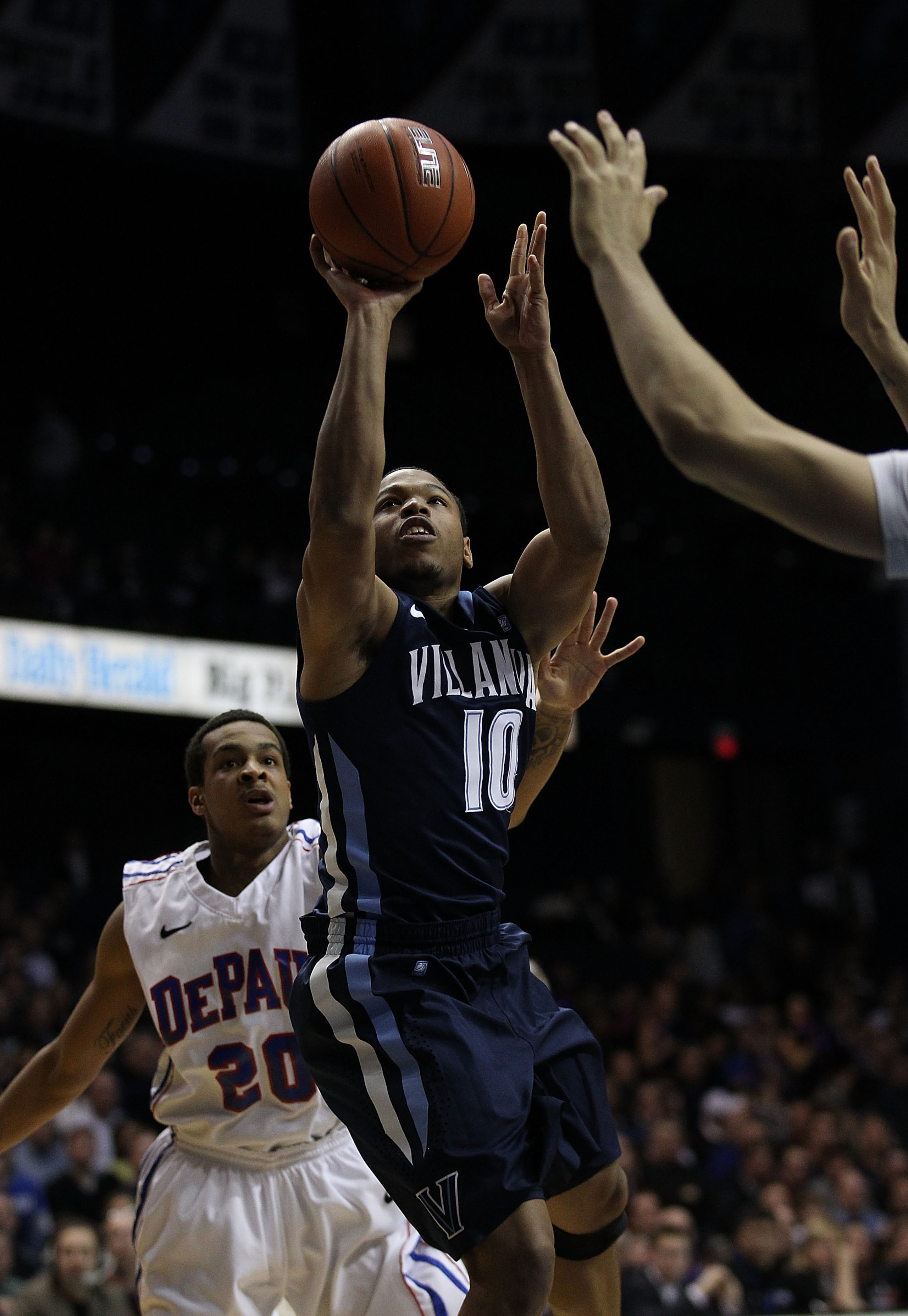 ROSEMONT, IL - FEBRUARY 19: Corey Fisher #10 of the Villanova Wildcats puts up a shot past Brandon Young #20 of the DePaul Blue Demons at the Allstate Arena on February 19, 2011 in Rosemont, Illinois. Villanova defeated DePaul 77-75 in overtime. (Photo by