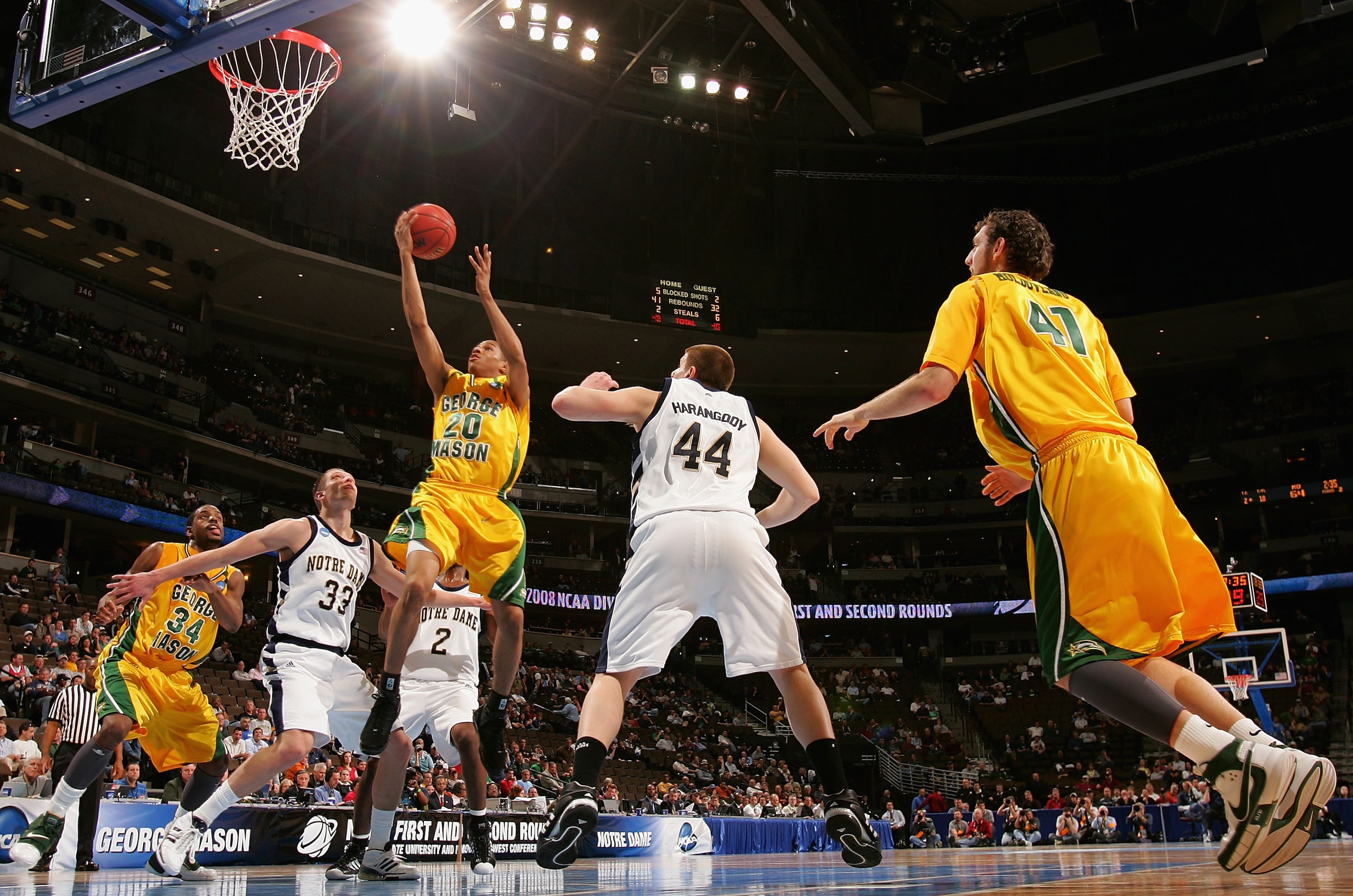 DENVER - MARCH 20:  Cam Long #20 of the George Mason Patriots lays up a shot against Zach Hillesland #33 of the Notre Dame Fighting Irish during the first round of the East Regional as part of the 2008 NCAA Men's Basketball Tournament at Pepsi Center on M
