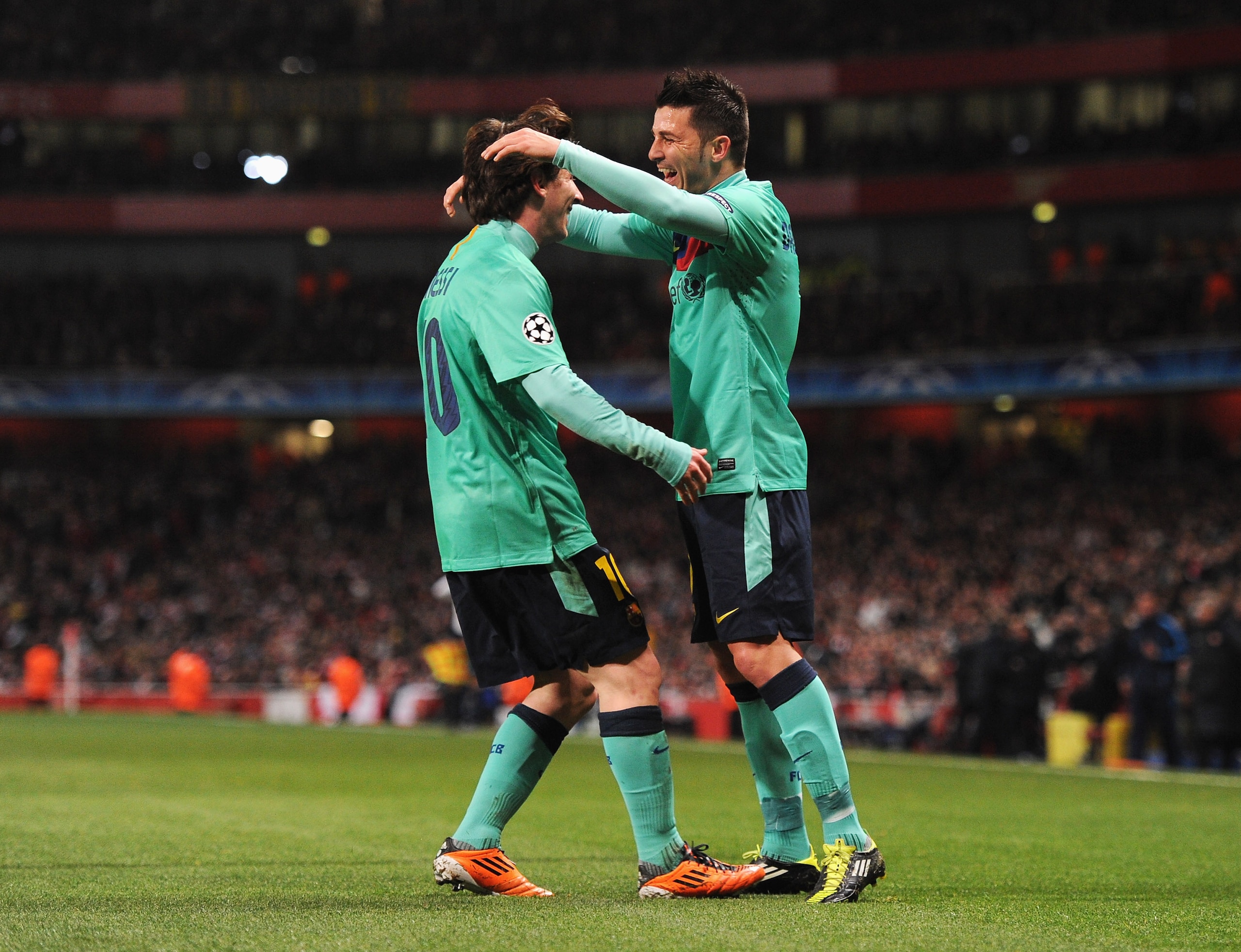 LONDON, ENGLAND - FEBRUARY 16:  David Villa (R) of Barcelona celebrates scoring the opening goal with Lionel Messi during the UEFA Champions League round of 16 first leg match between Arsenal and Barcelona at the Emirates Stadium on February 16, 2011 in L