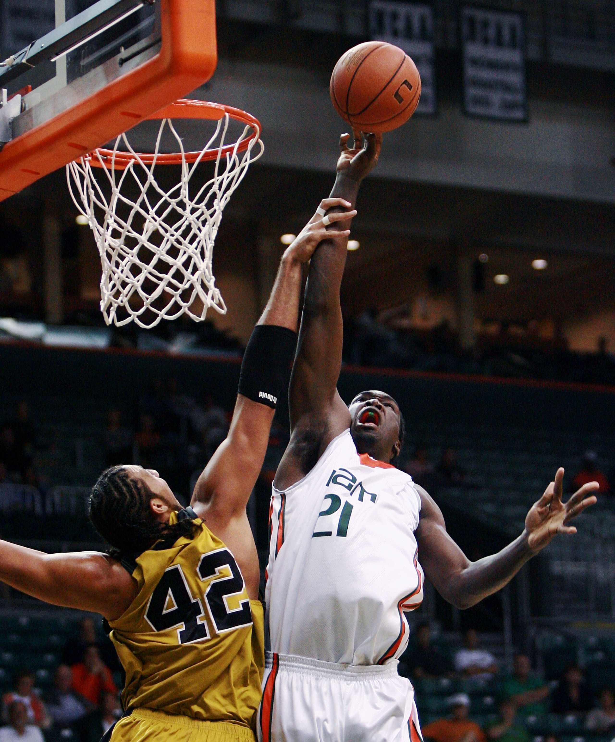 MIAMI - NOVEMBER 28:  Jamarr Sanders #21 of the Miami Hurricanes is fouled by Chief Kickingstallionsims #42 of the Alabama State Hornets at BankUnited Center on November 28,  2007 in Miami, Florida.  (Photo by Doug Benc/Getty Images)