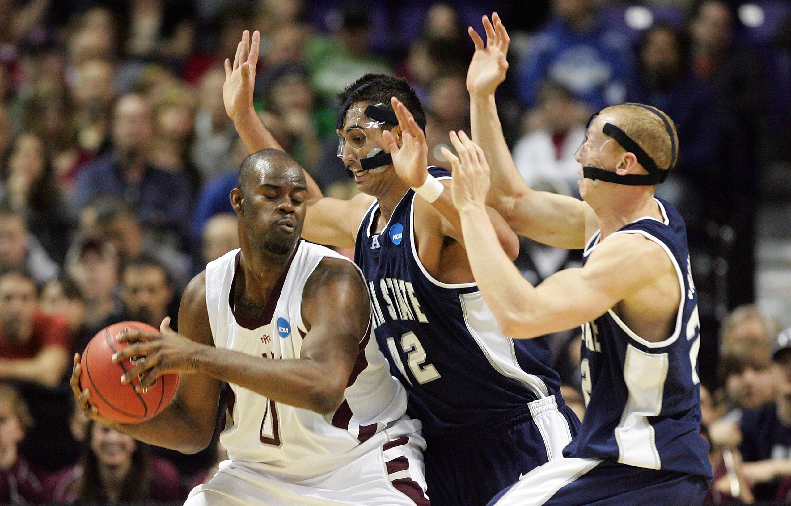 SPOKANE, WA - MARCH 19:  Bryan Davis #0 of the Texas A&M Aggies is defended by Tai Wesley #42 and Brady Jardine #22 of the Utah St. Aggies during the first round of the 2010 NCAA men's basketball tournament at Spokane Arena on March 19, 2010 in Spokane, W